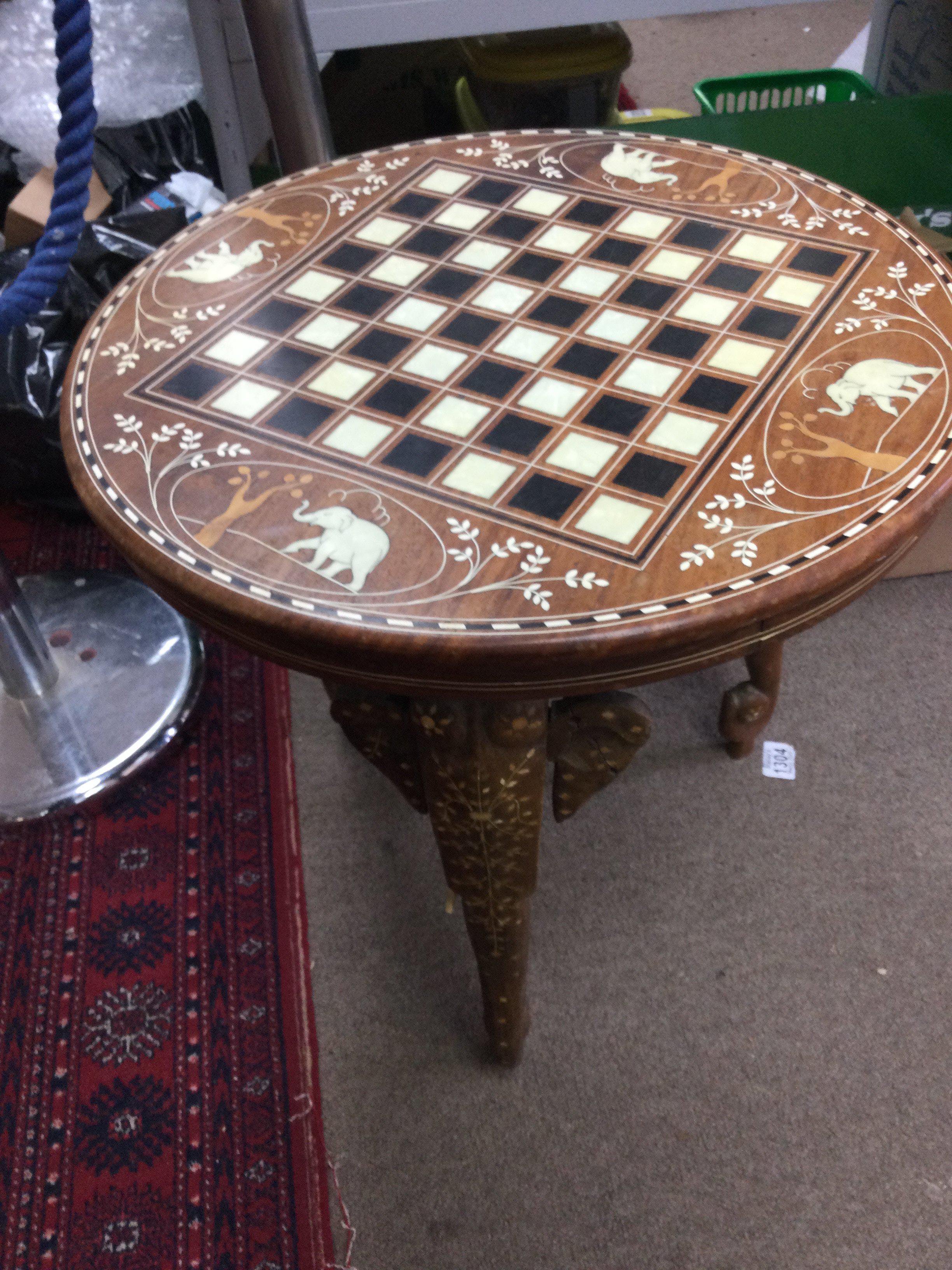 A inlaid occasional table with game board inset in mother of pearl.