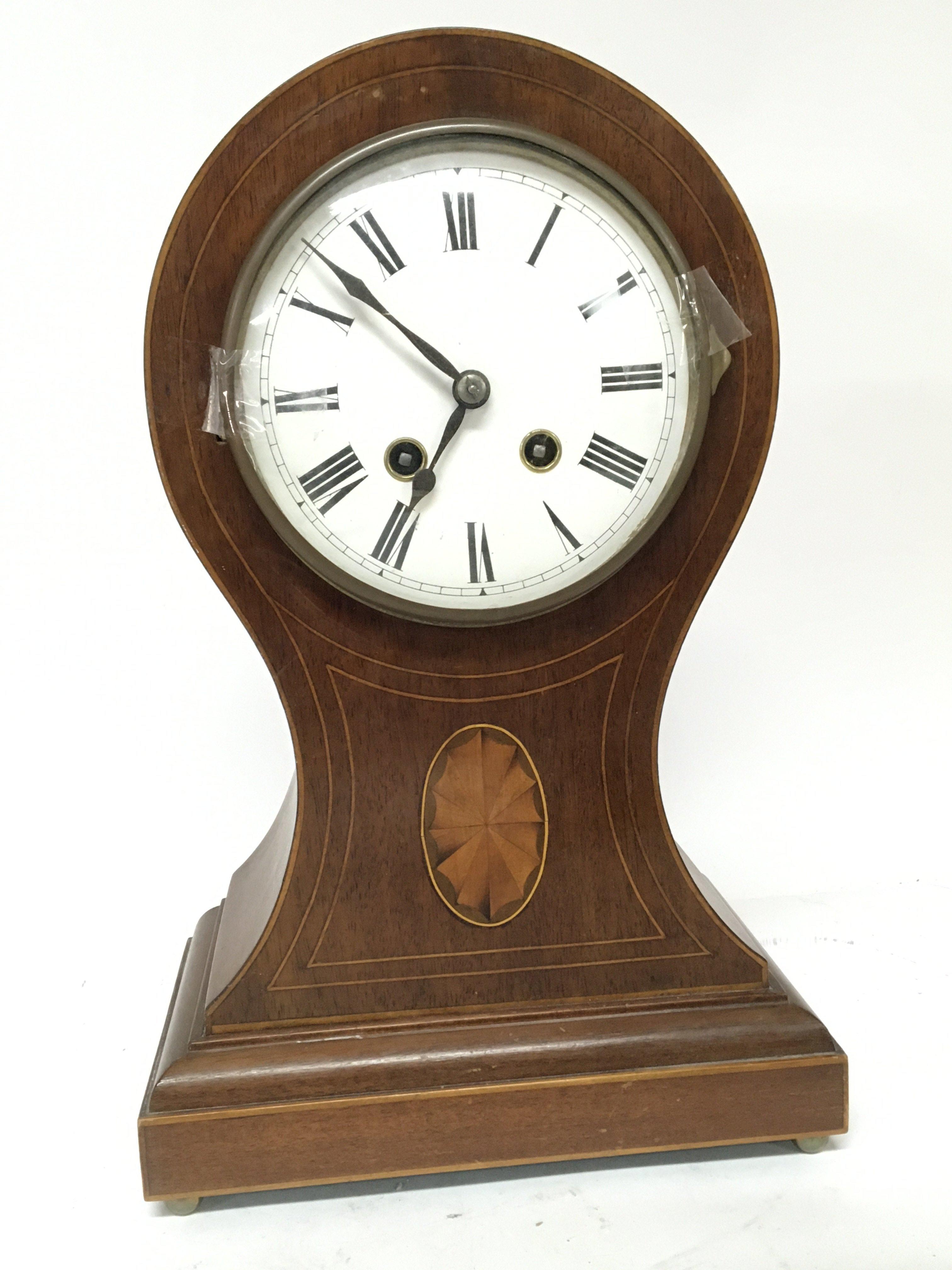 An Edwardian inlaid Mahogany mantel clock with balloon shaped case brass movement striking on a gong with pendulum height 35cm