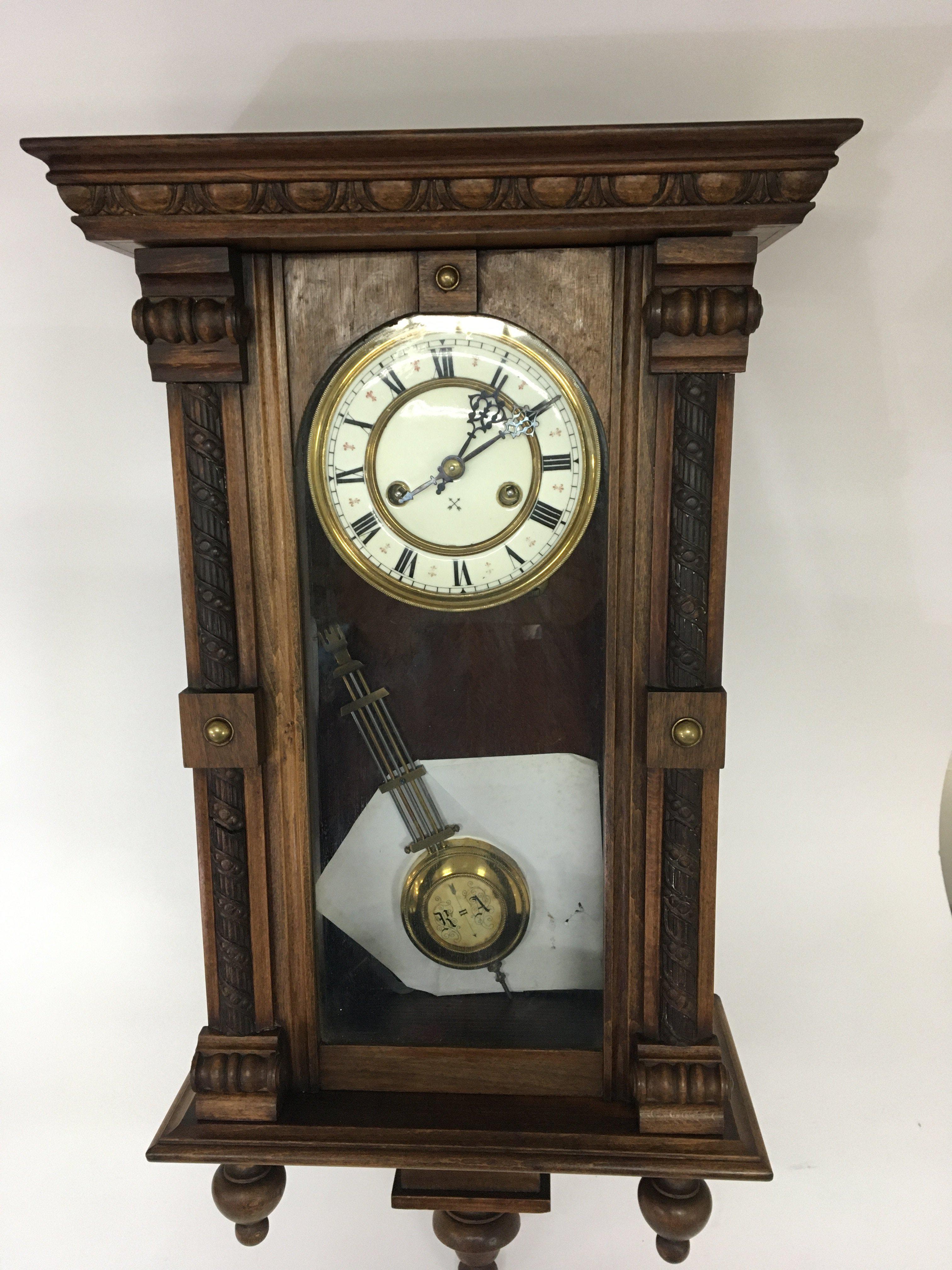 Two Vienna Type walnut cased wall clocks with enamel dials key and pendulum.