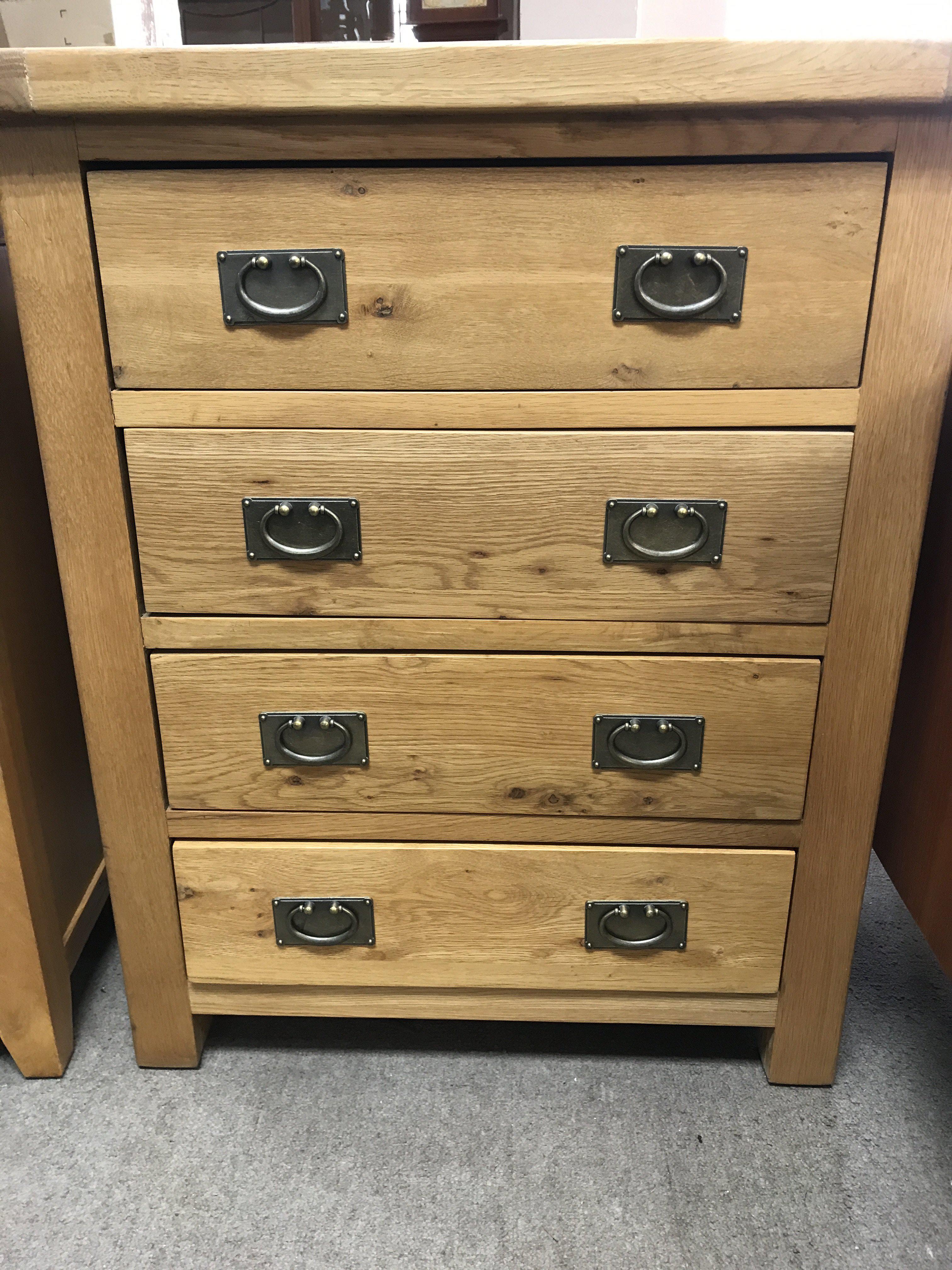 A pine chest of drawers the the rectangle top above four drawers .