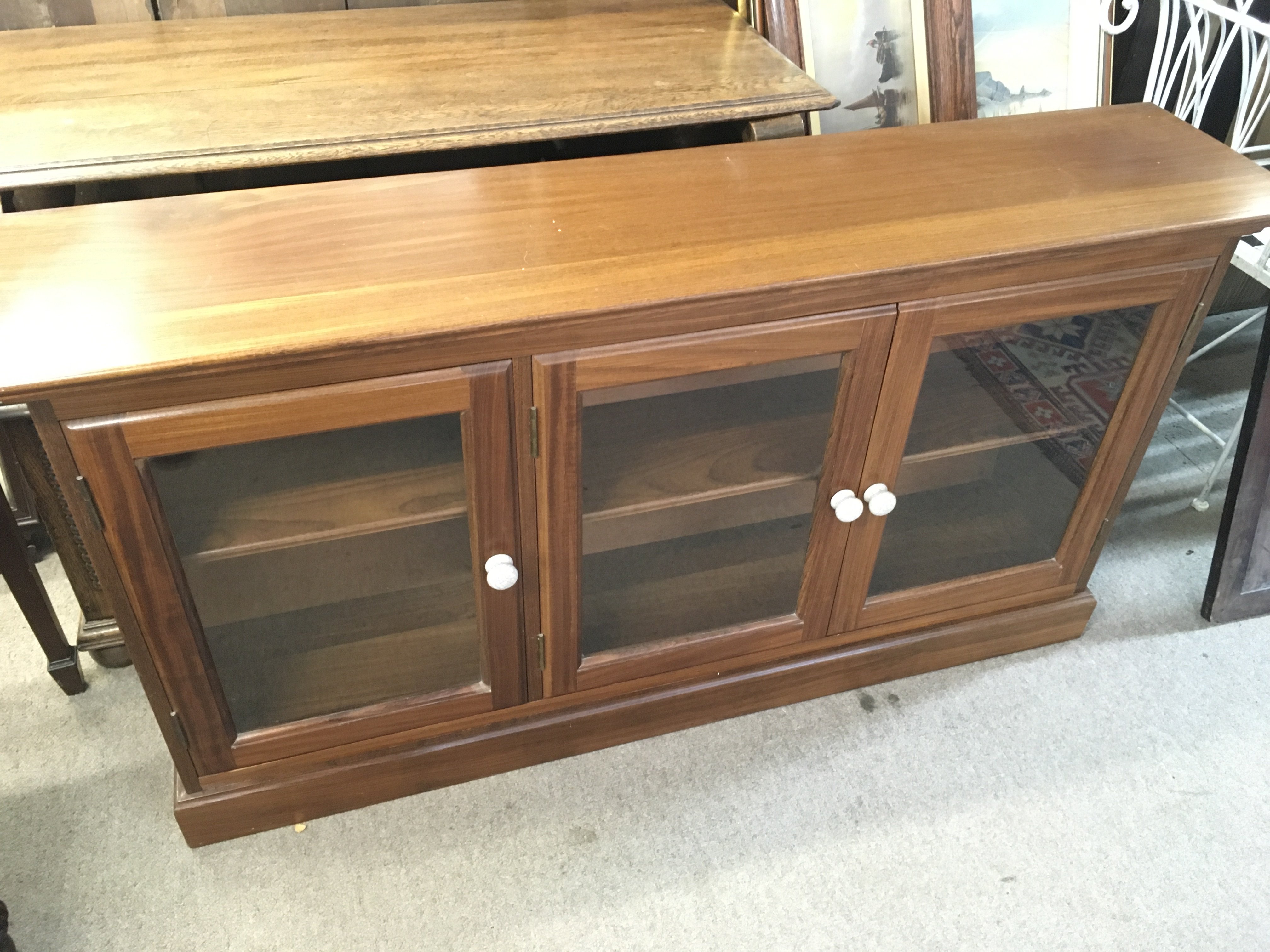 A quality modern bookcase with glass fronted doors. 137x30x74cm