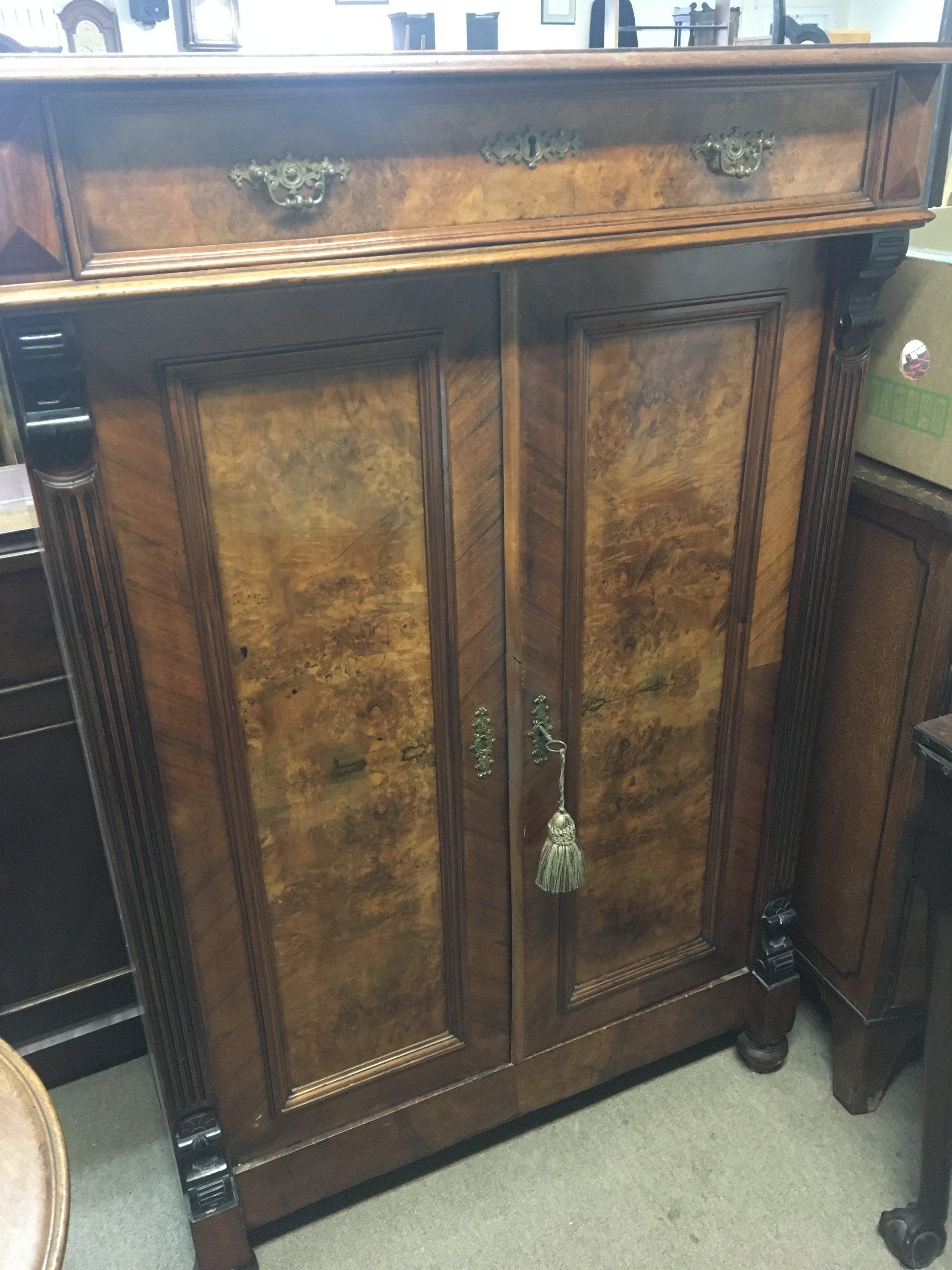 A Continental burr walnut cabinet fitted with a single drawer above cupboards. Hight 136cm x95cm