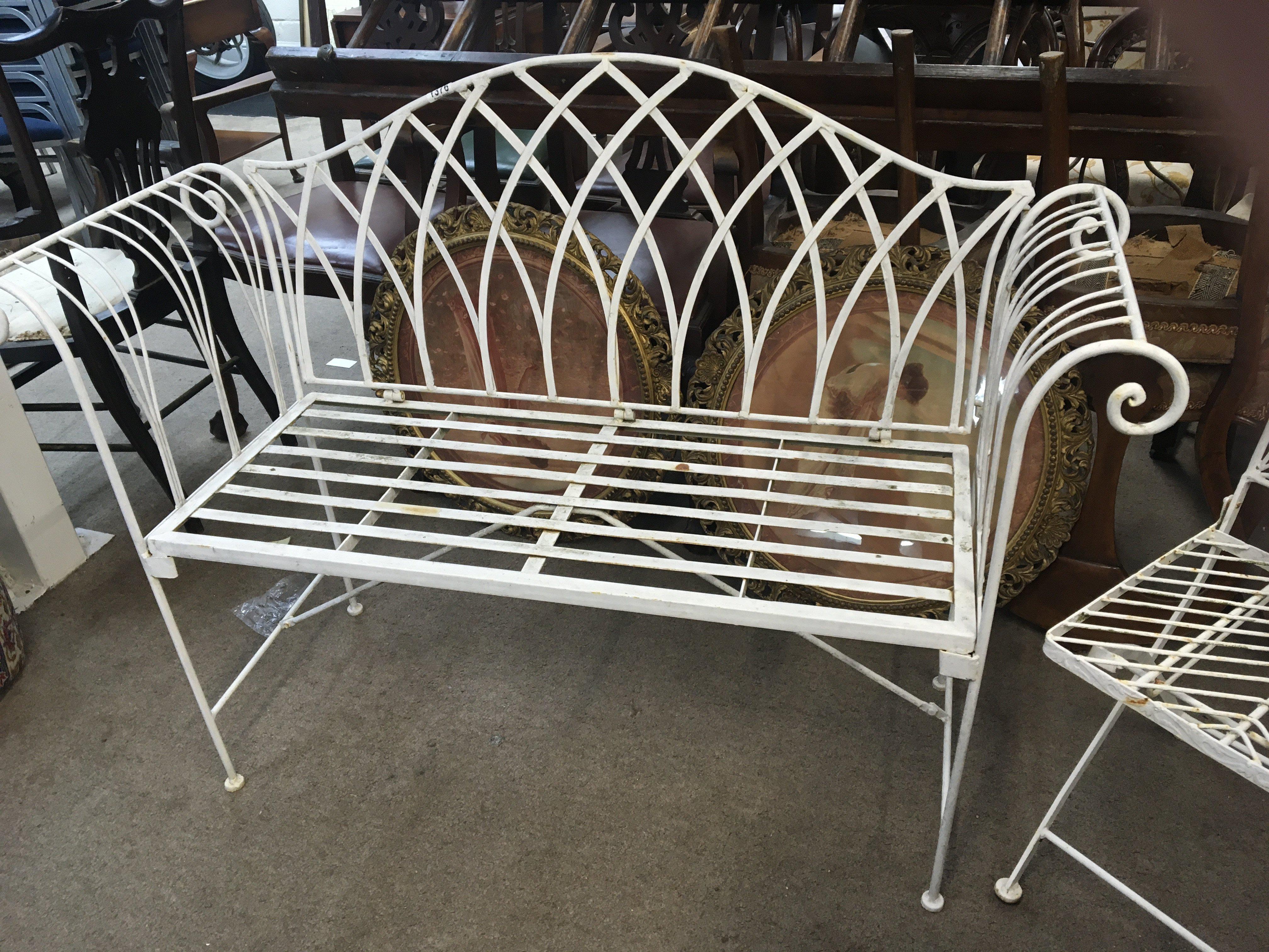 A Regency style wrought iron folding garden seat and one other folding garden seat (2)