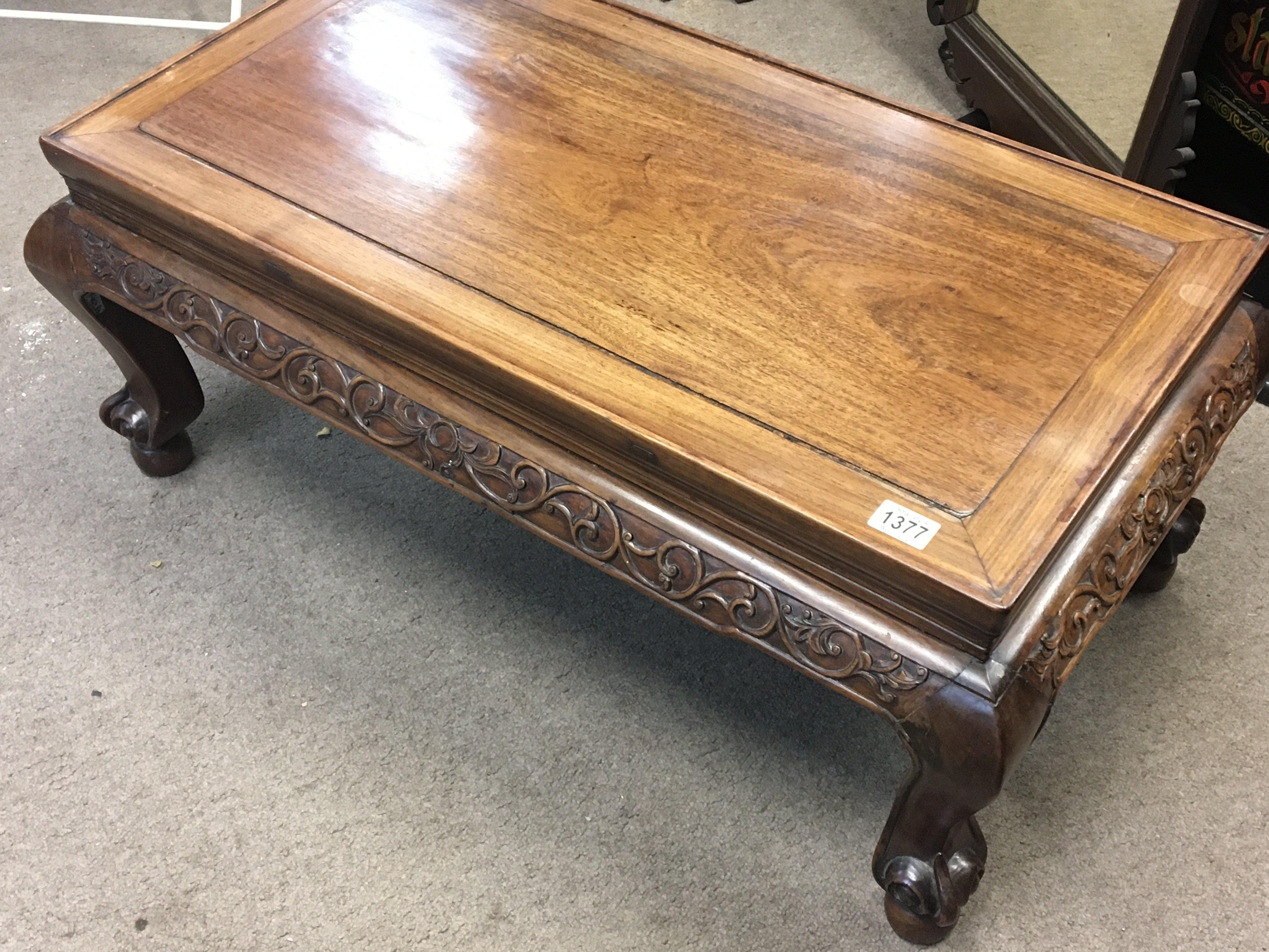 A 20th century Chinese carved hardwood rectangular coffee table with shaped legs.