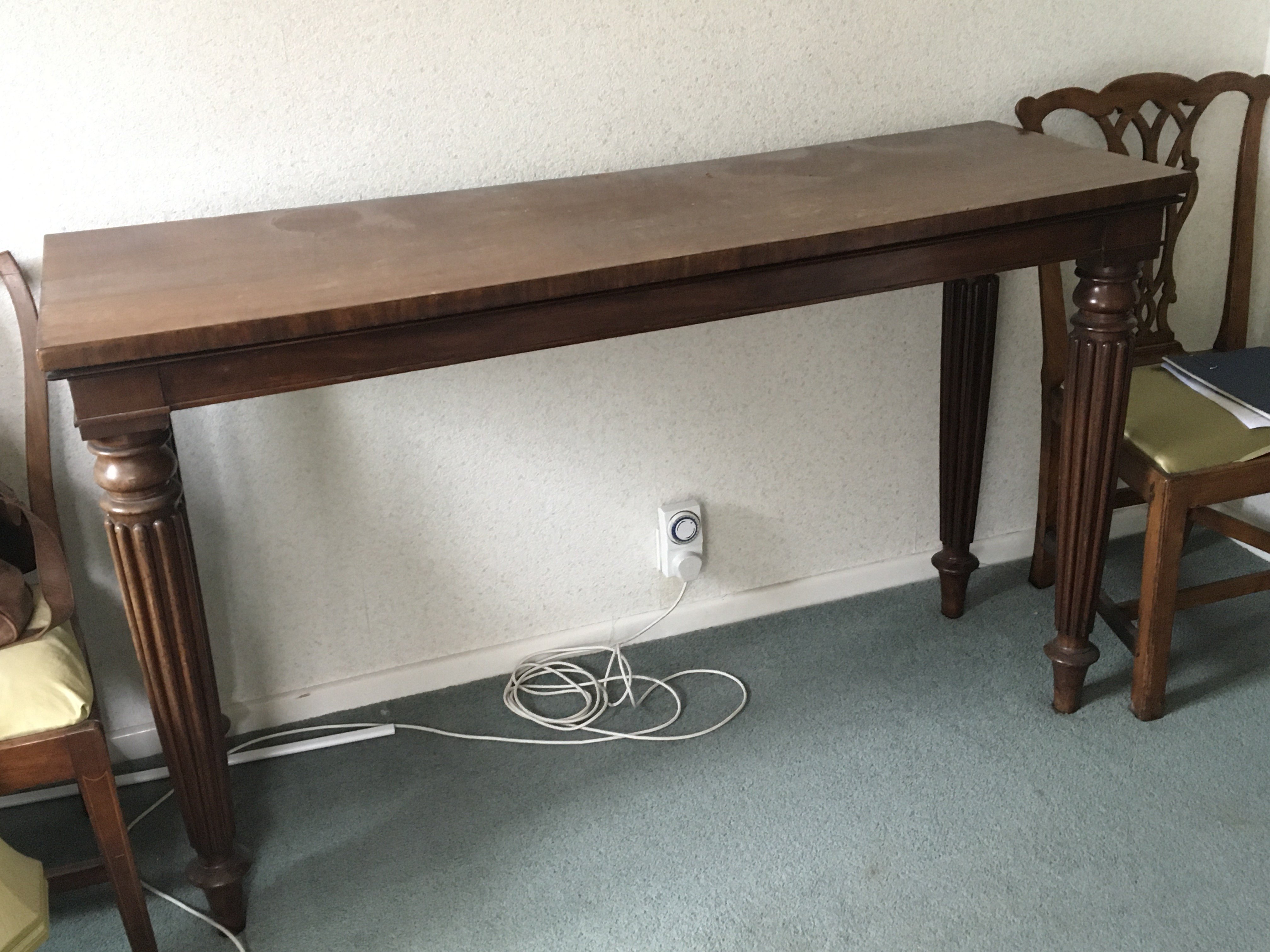 An Early Victorian Mahogany serving table the rectangular top on turned and tapering reeded legs length 153cm.