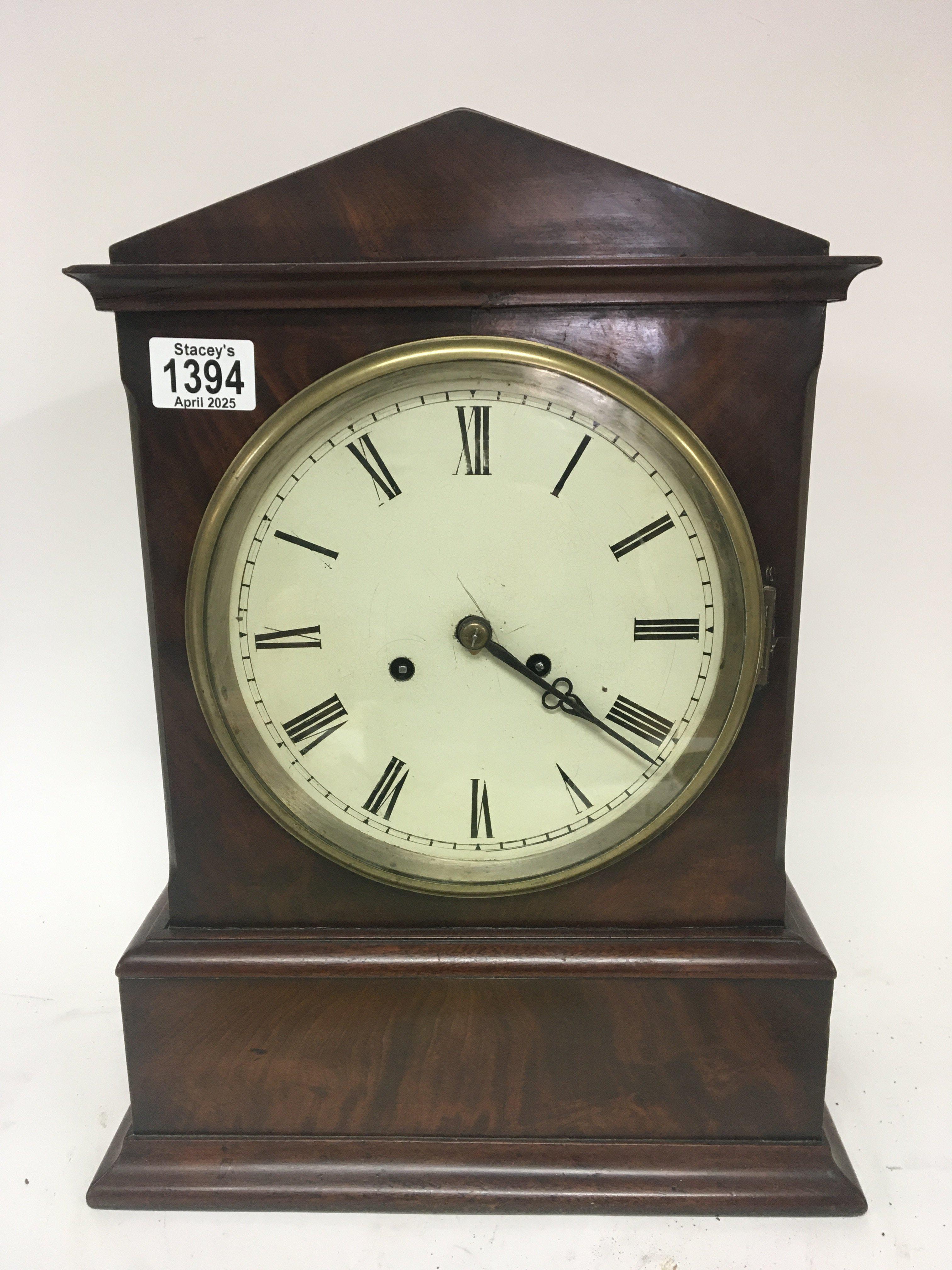 An Early Victorian mahogany mantel or bracket clock with a double fusee brass movement striking on a bell 43cm heigh. With pendulum.