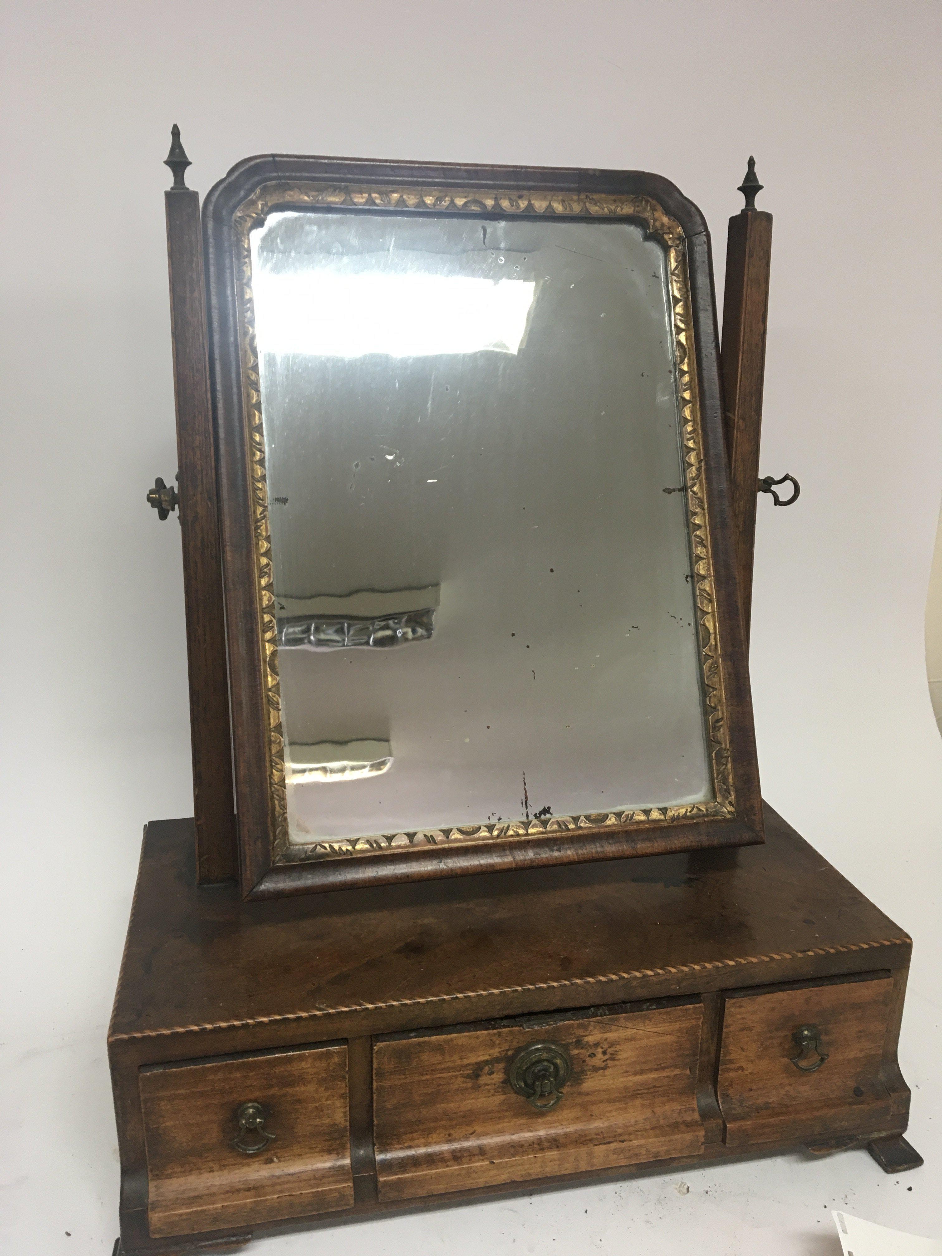 A George III mahogany dressing table mirror with three drawers.