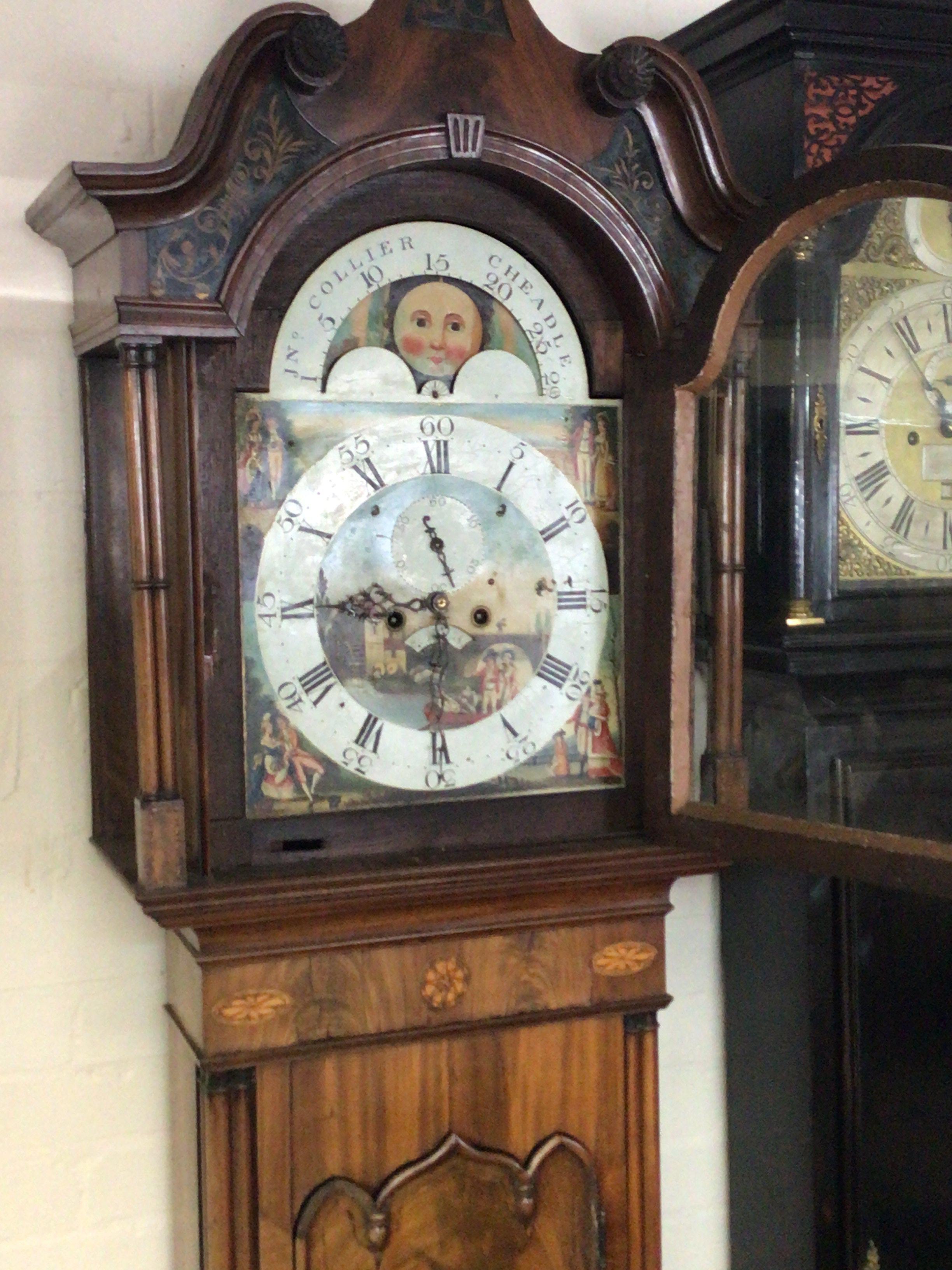 An elaborate Mahogany George III long case clock the inlaid case with fluted pilasters with an arches swan neck pediment with a painted dial and moon roller eight day going with weights and pendulum.