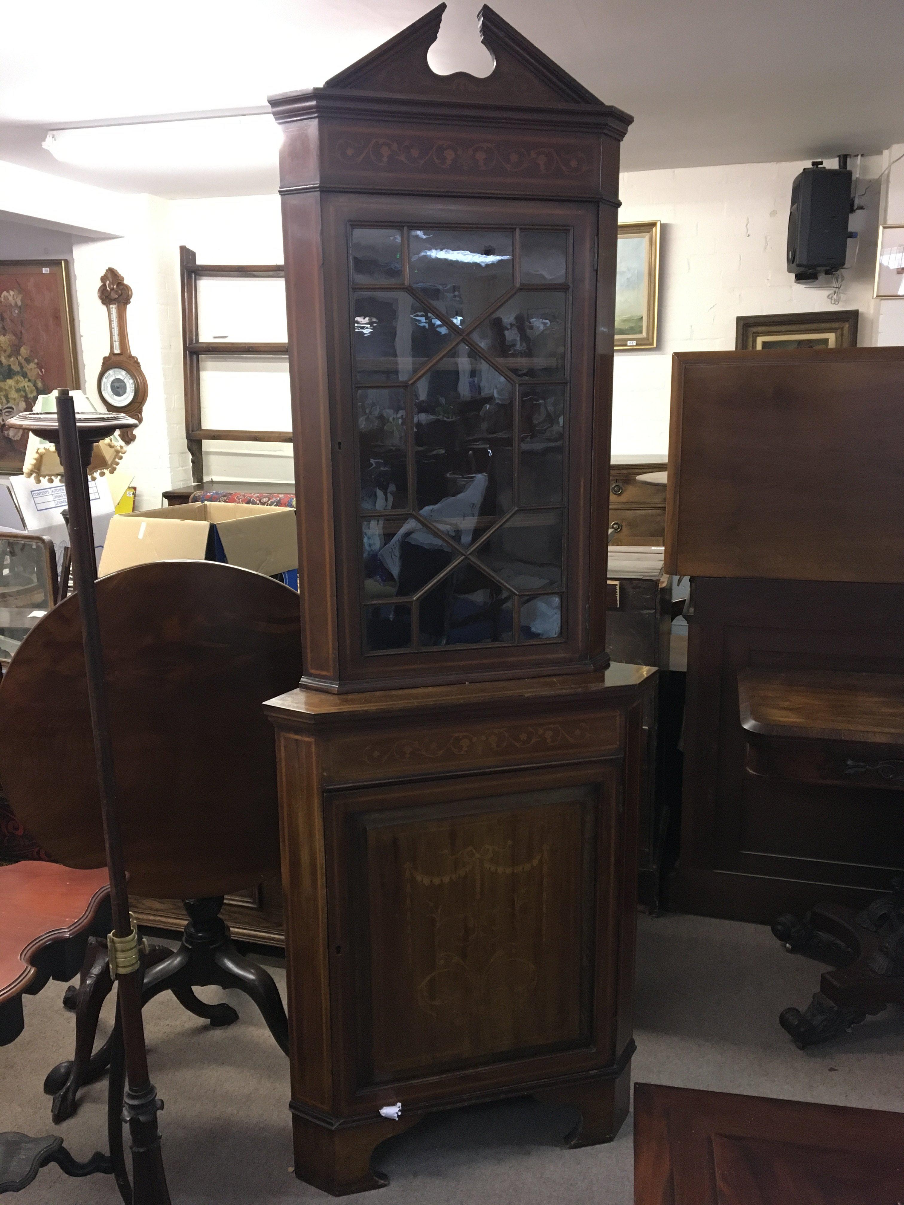An Edwardian inlaid mahogany corner cabinet with a single glazed door above satinwood inlaid cupboard door.