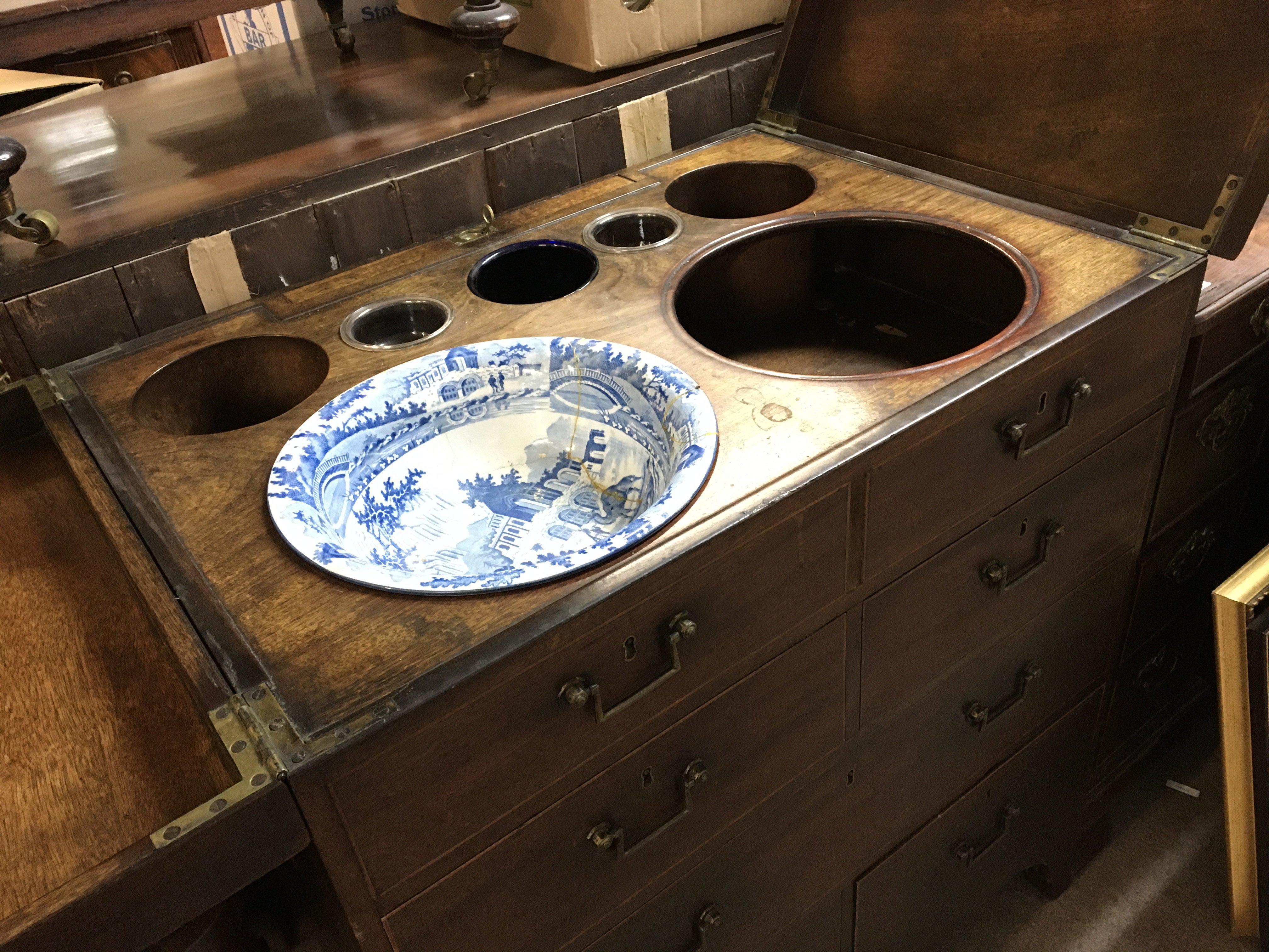 A Quality George III mahogany campaign type dressing chest. The sides with brass carrying handles the hinged top section with retractable mirror and fitted wash bowl compartment. above drawers with well fitted interior.on bracket feet. 76cm wide 88cm high