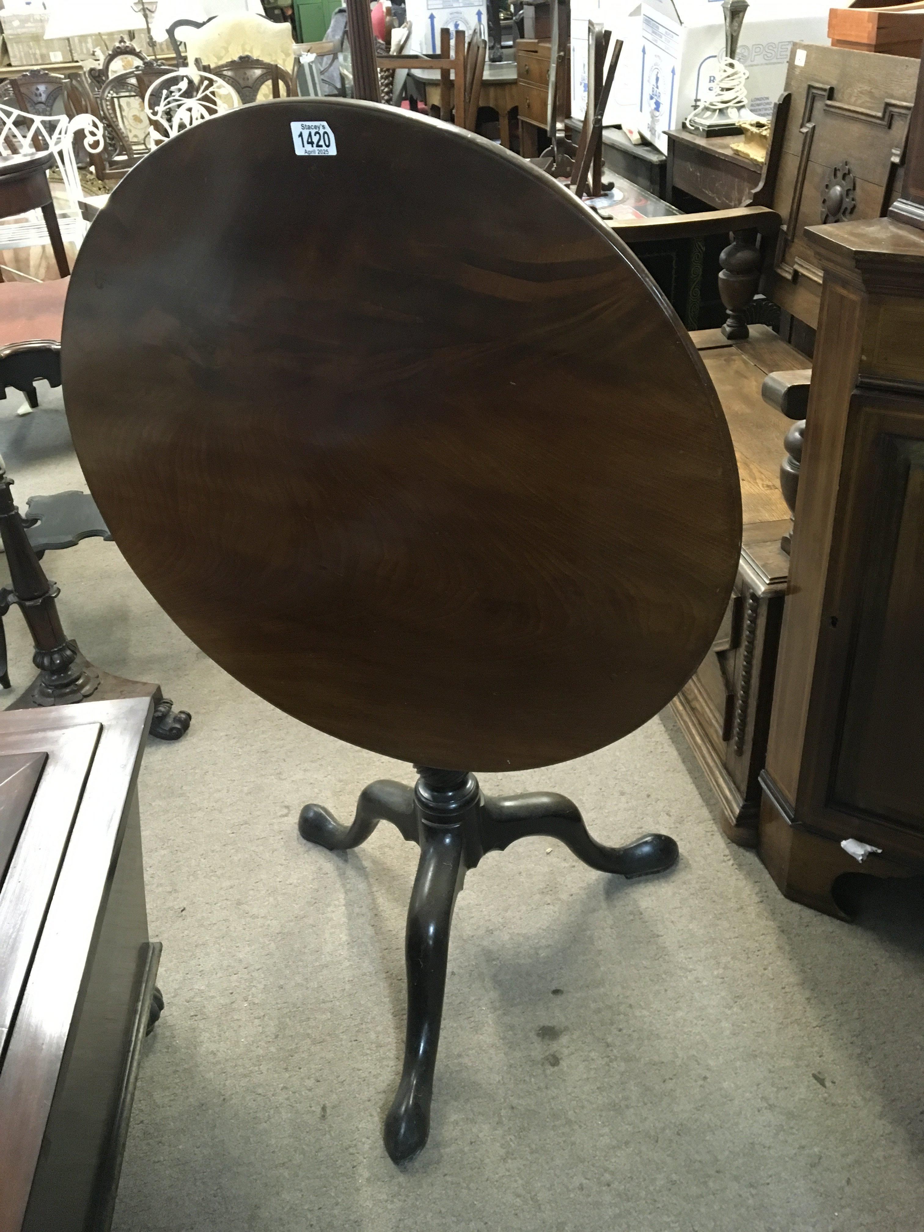 A Quality George III mahogany tip action table the solid round top above a bird cage four pillar revolving action. On a turned column and splayed legs. 73cm wide.