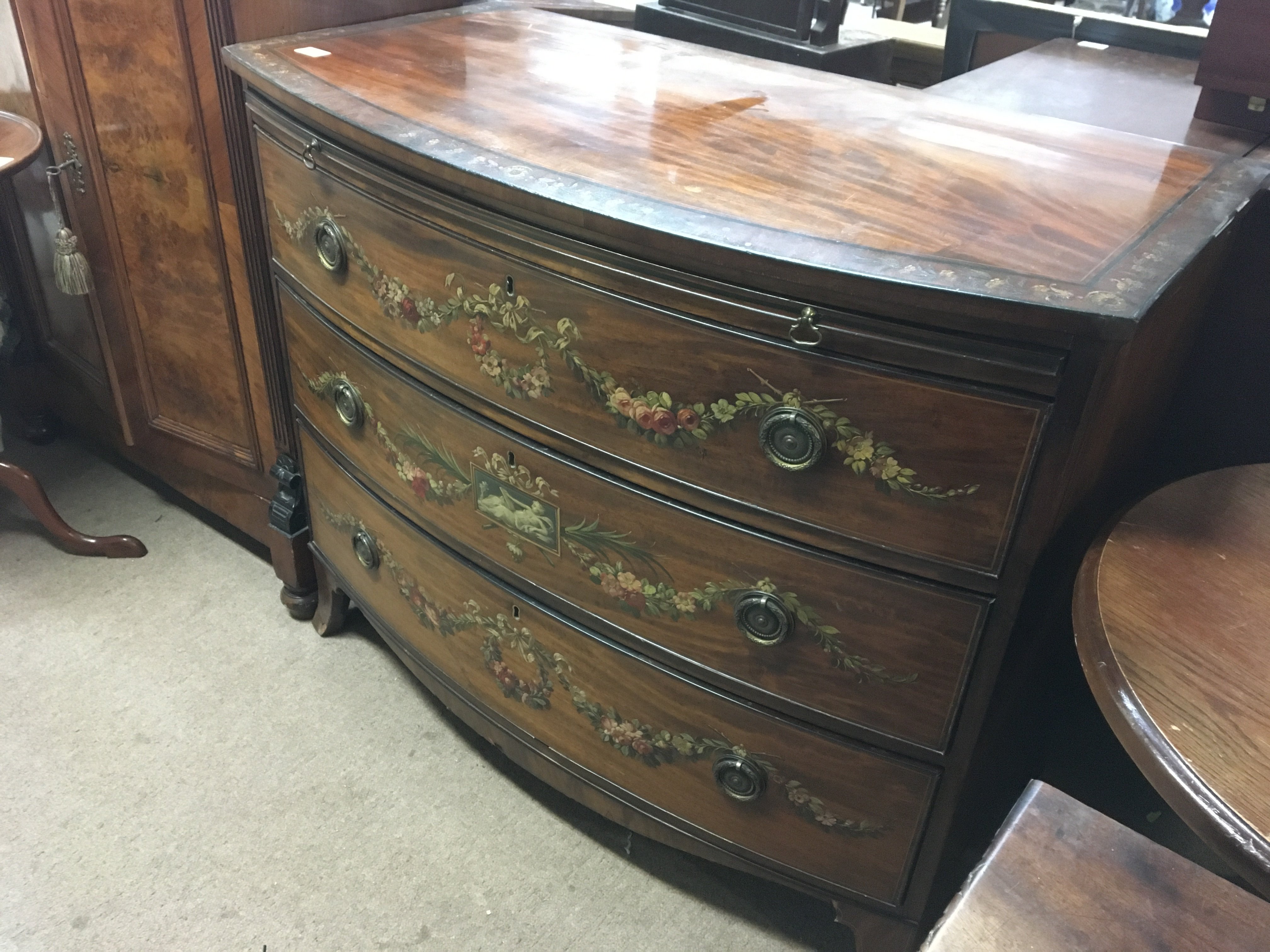 A Quality late George III hand painted bow fronted chest of drawers with a brushing slide on swept bracket feet. Length 42cm