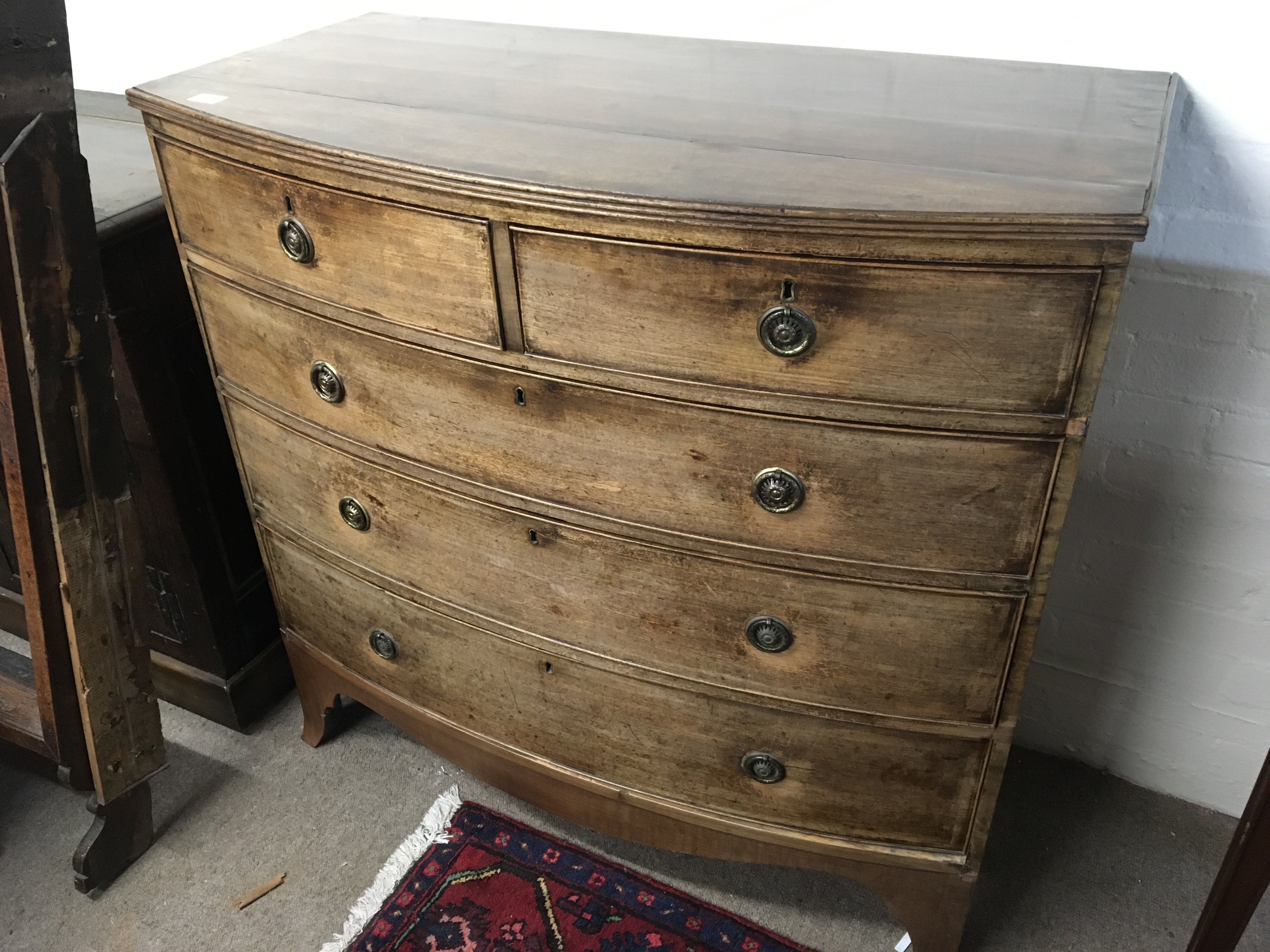 A late George III mahogany bow fronted chest of drawers fitted with two short and three long drawers on swept bracket feet length 109cm