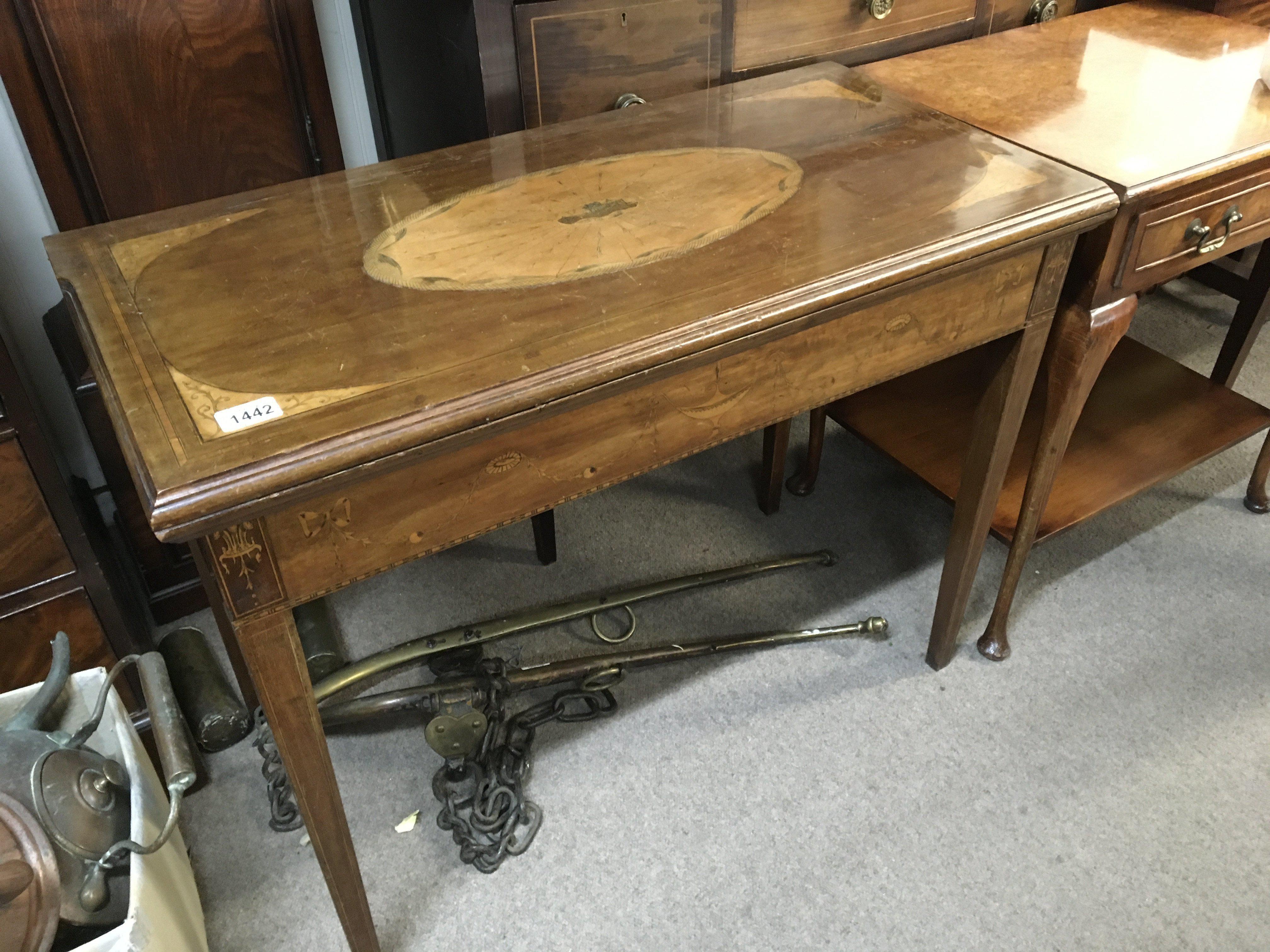 An Edwardian inlaid mahogany card table the rectangular top with a satinwood fan shaped oval medallion