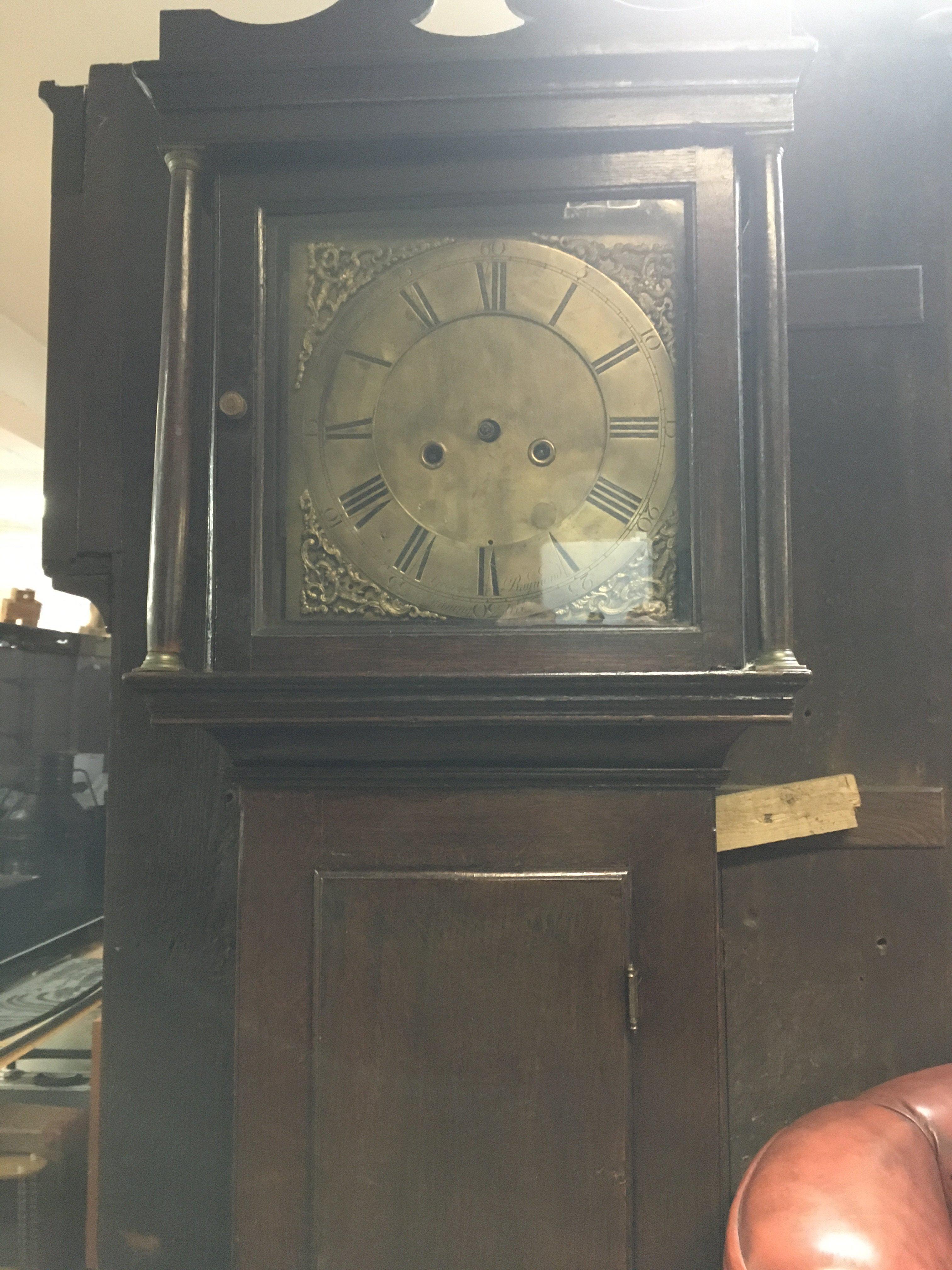 A oak long case clock the brass dial with Roman numerals. NO RESERVE