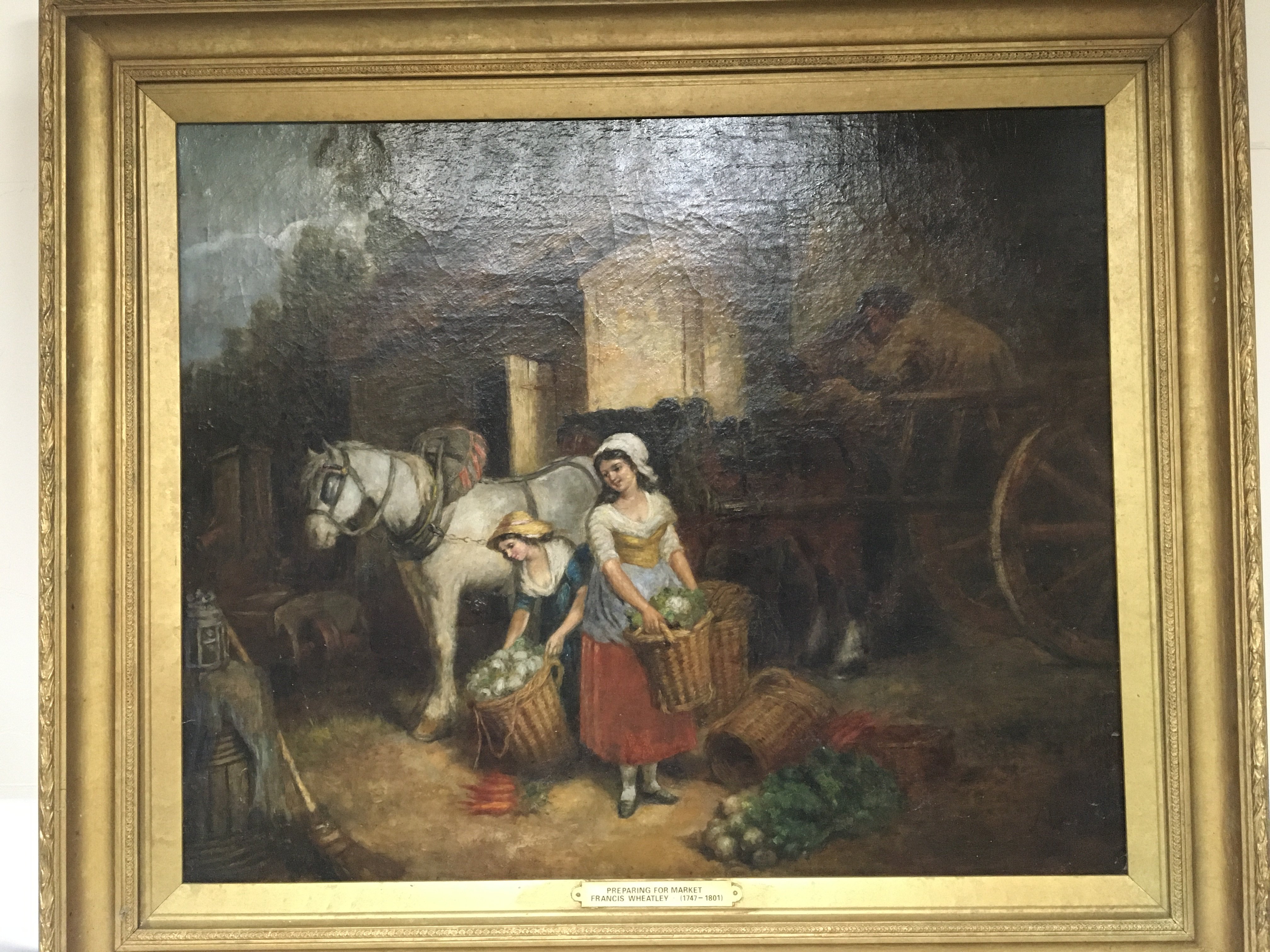 A pen oil painting on canvas depicting ladies with baskets of vegetables with a harnessed working horse The Painting Entitled Preparing for Market attributed to Francis Wheatley 1747-1801. 90x78cm