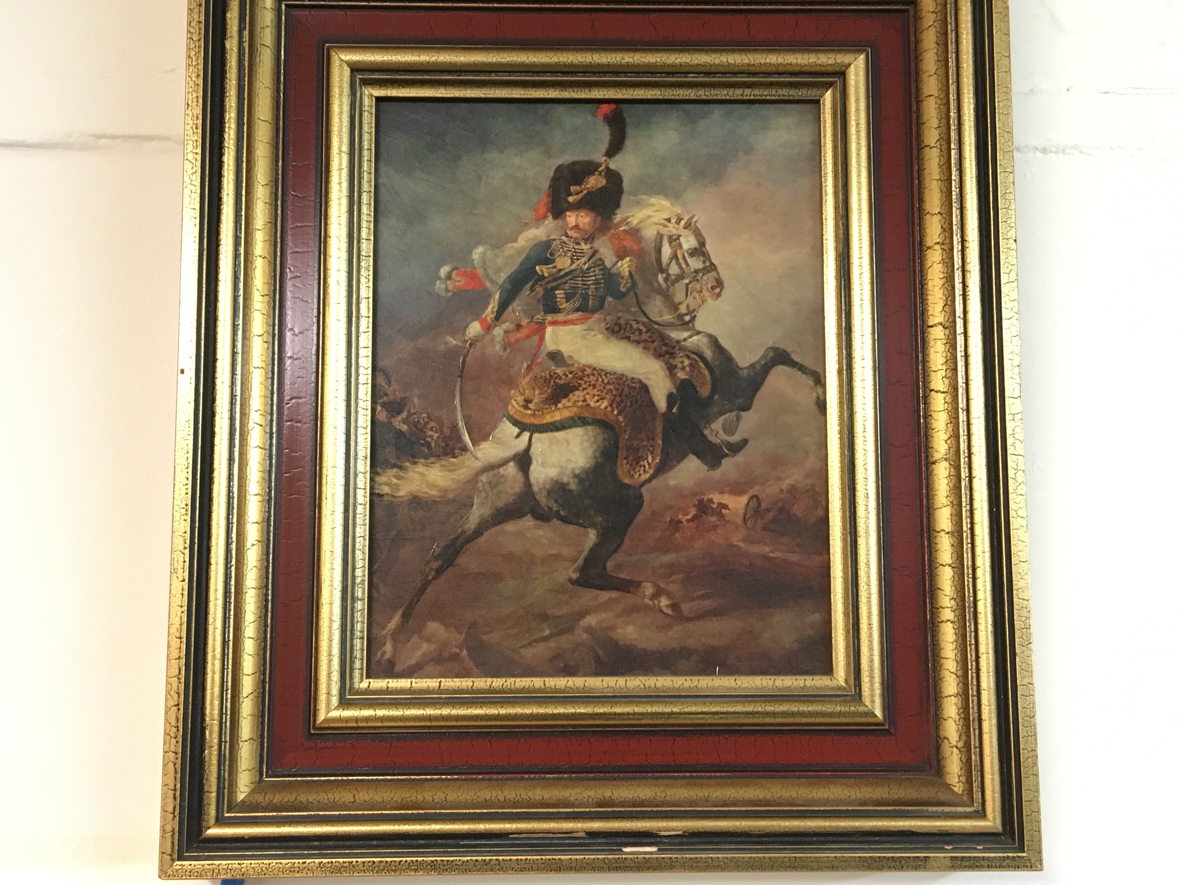 A framed oil on board painting titled The Charging Chasseur.
