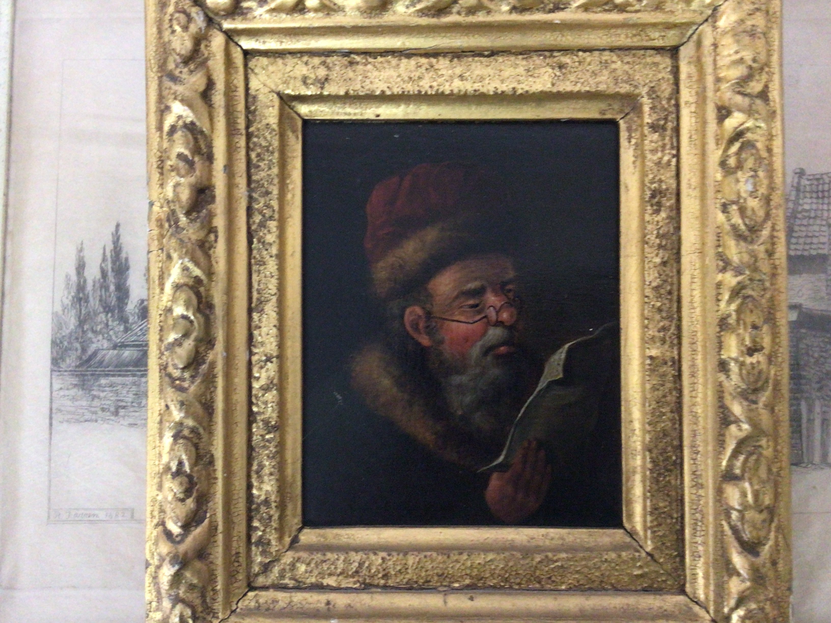 A small framed 19th century oil painting on panel portrait of a Continental figure reading a paper. A retrospective oil painting study of Dutch sailing ships and other oddments.
