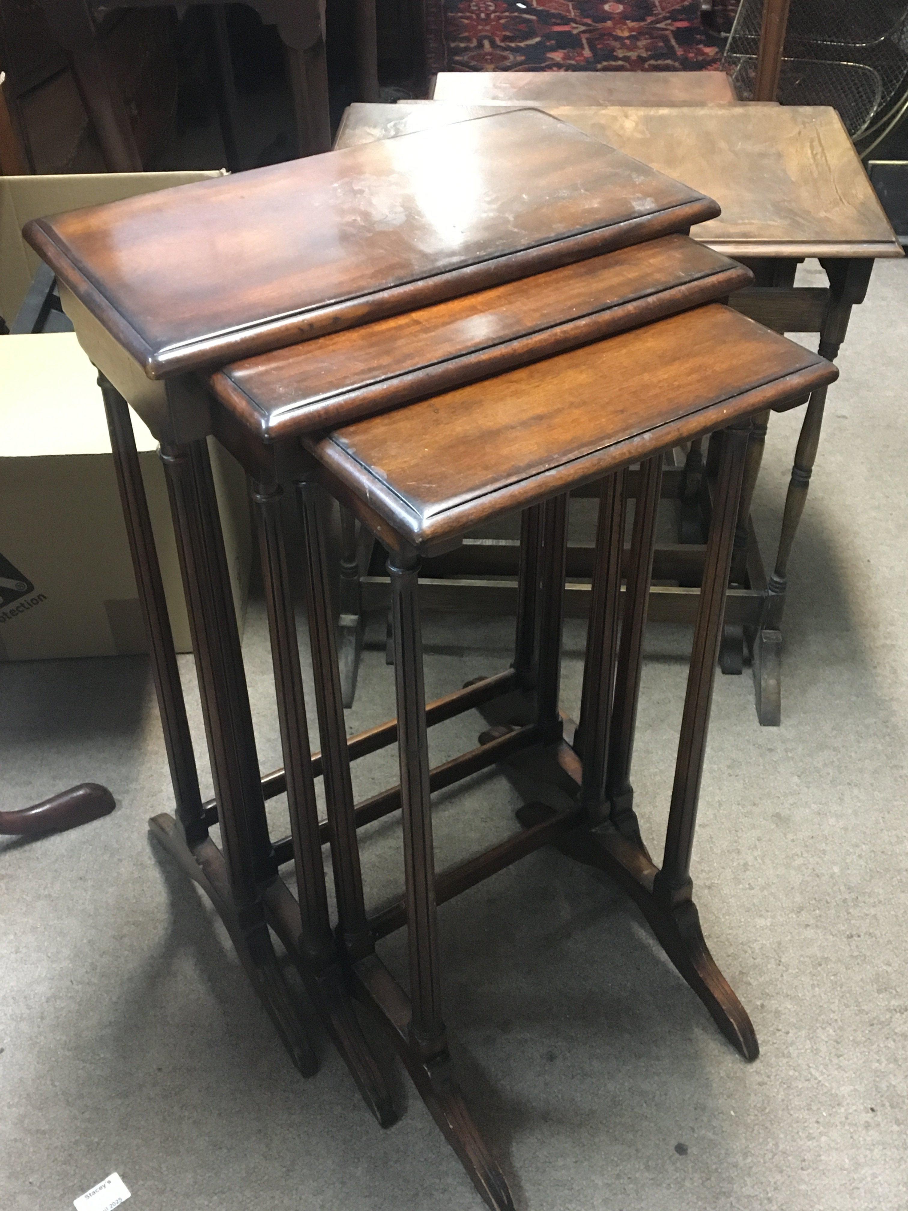 Two nests of three mahogany occasional tables (2)