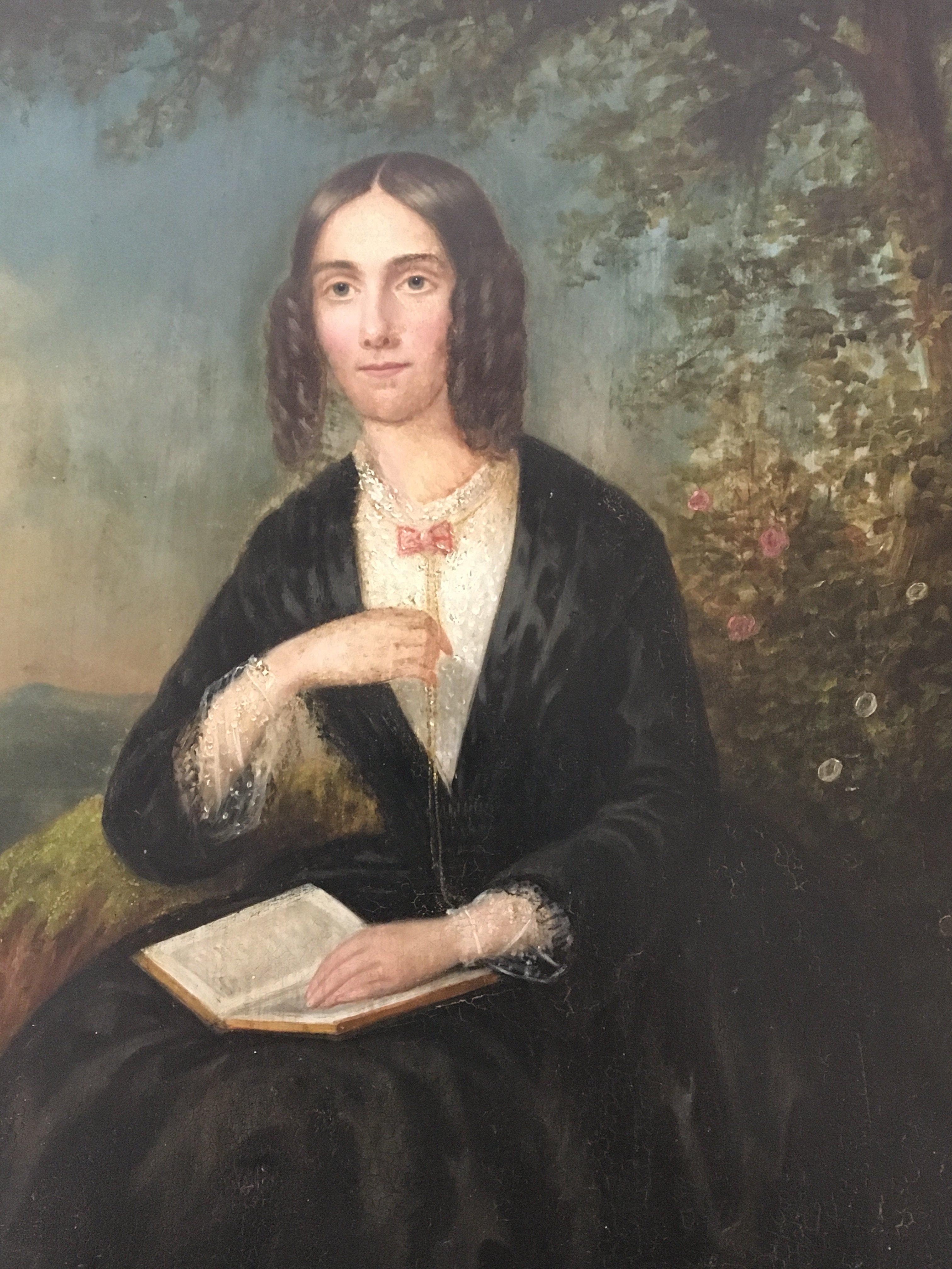 A Victorian oil painting on panel depicting a young lady reading a book unsigned and unattributed.