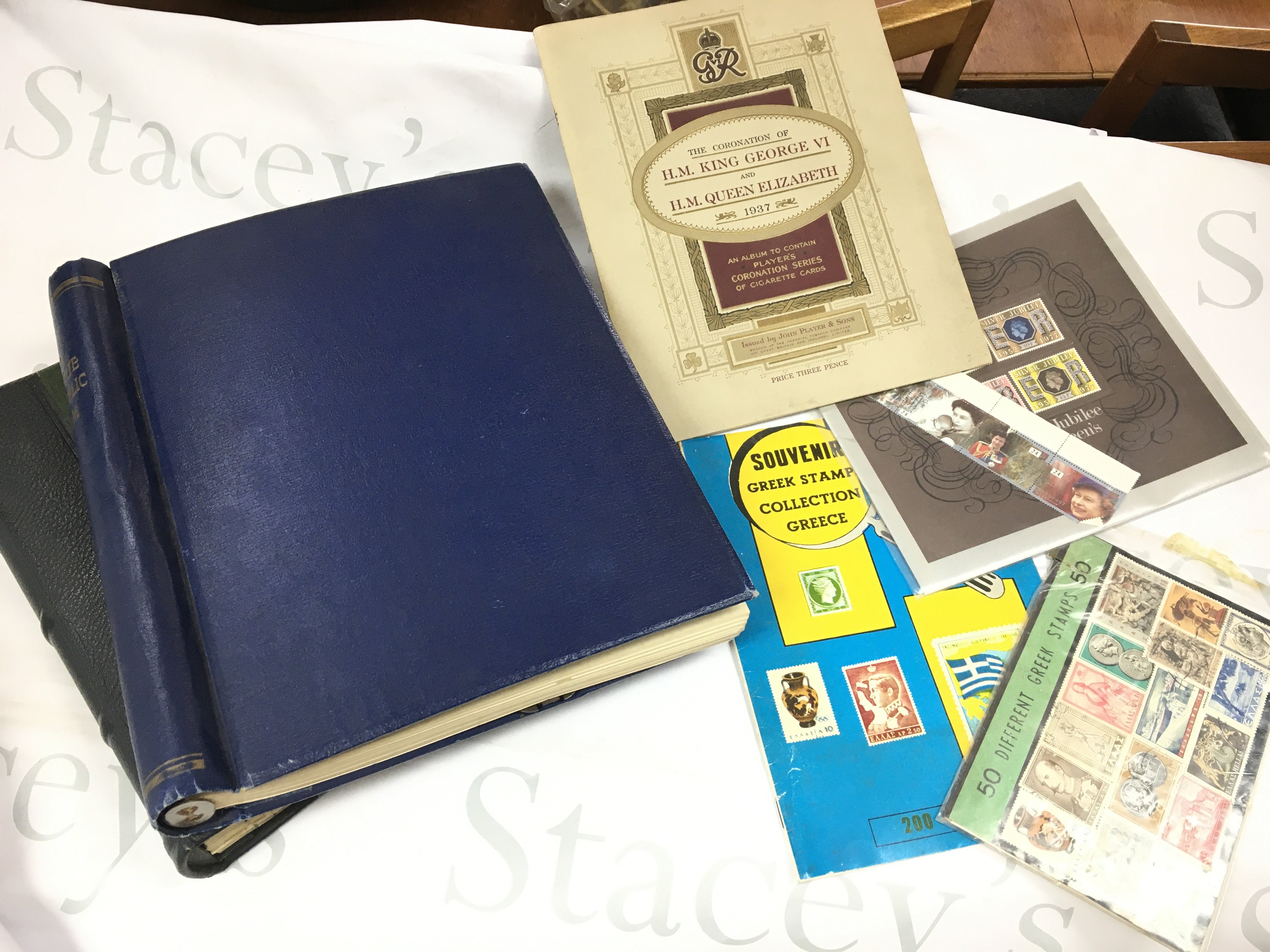 A collection of UK & World stamps including two albums , used and unused . Postage category C