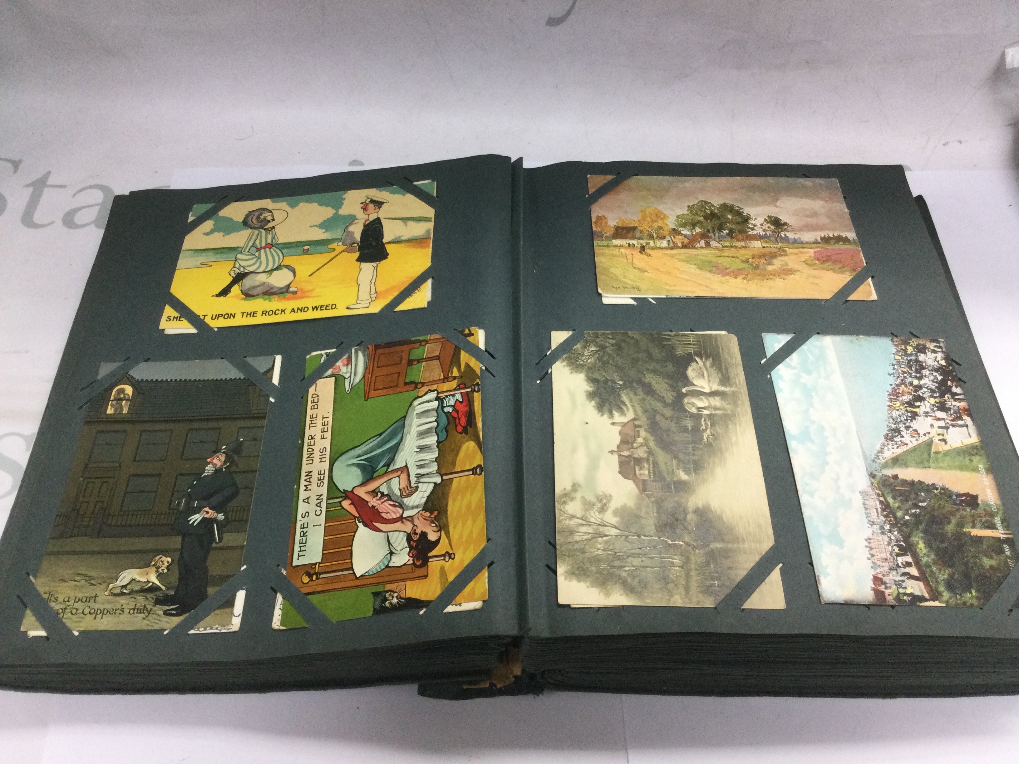 An album containing over 400 postcards including WW1, topographical, humorous etc. Shipping category B.