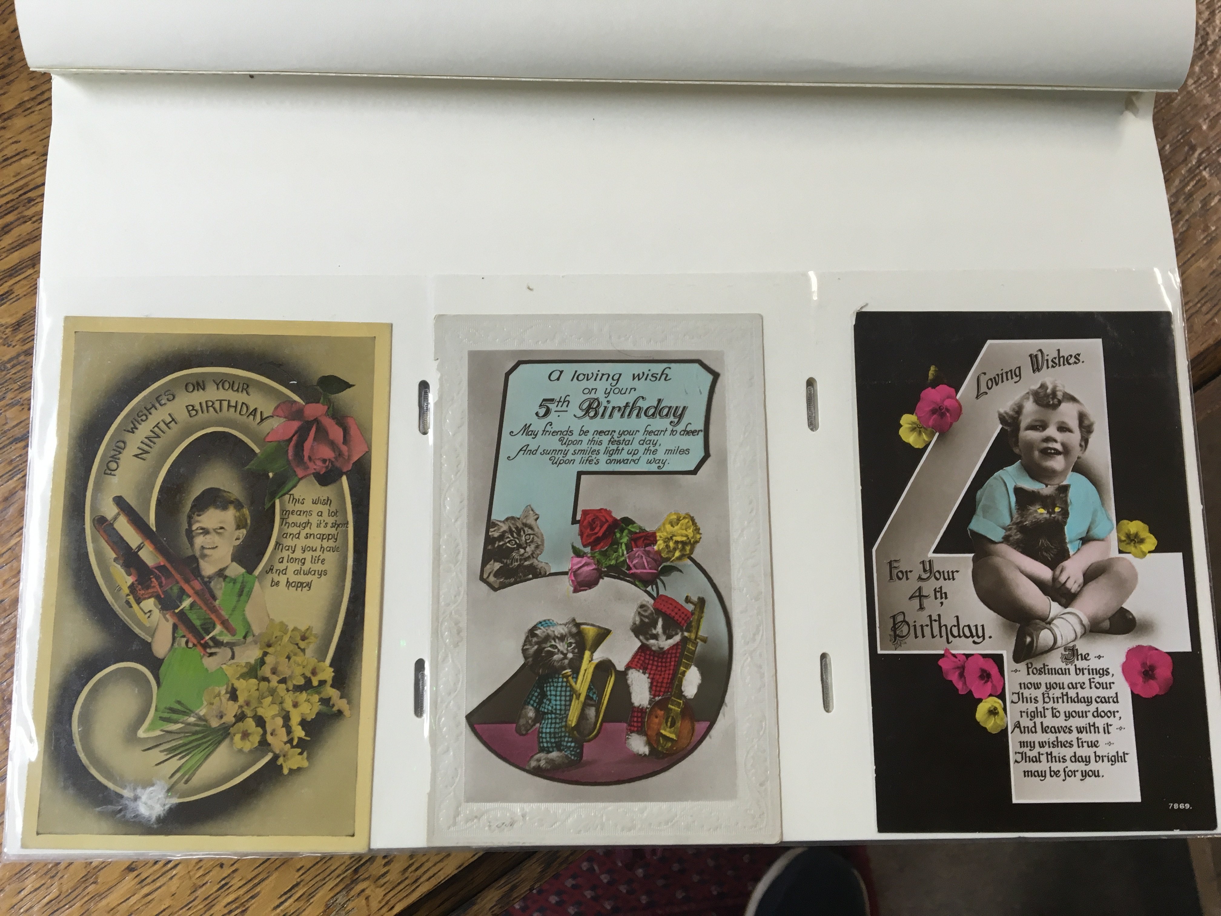 A box containing a collection of albums of postcards including a well presented album of Vintage greetings and Christmas cards albums containing vintage black and white postcards depicting Shipping cards and others. NO RESERVE