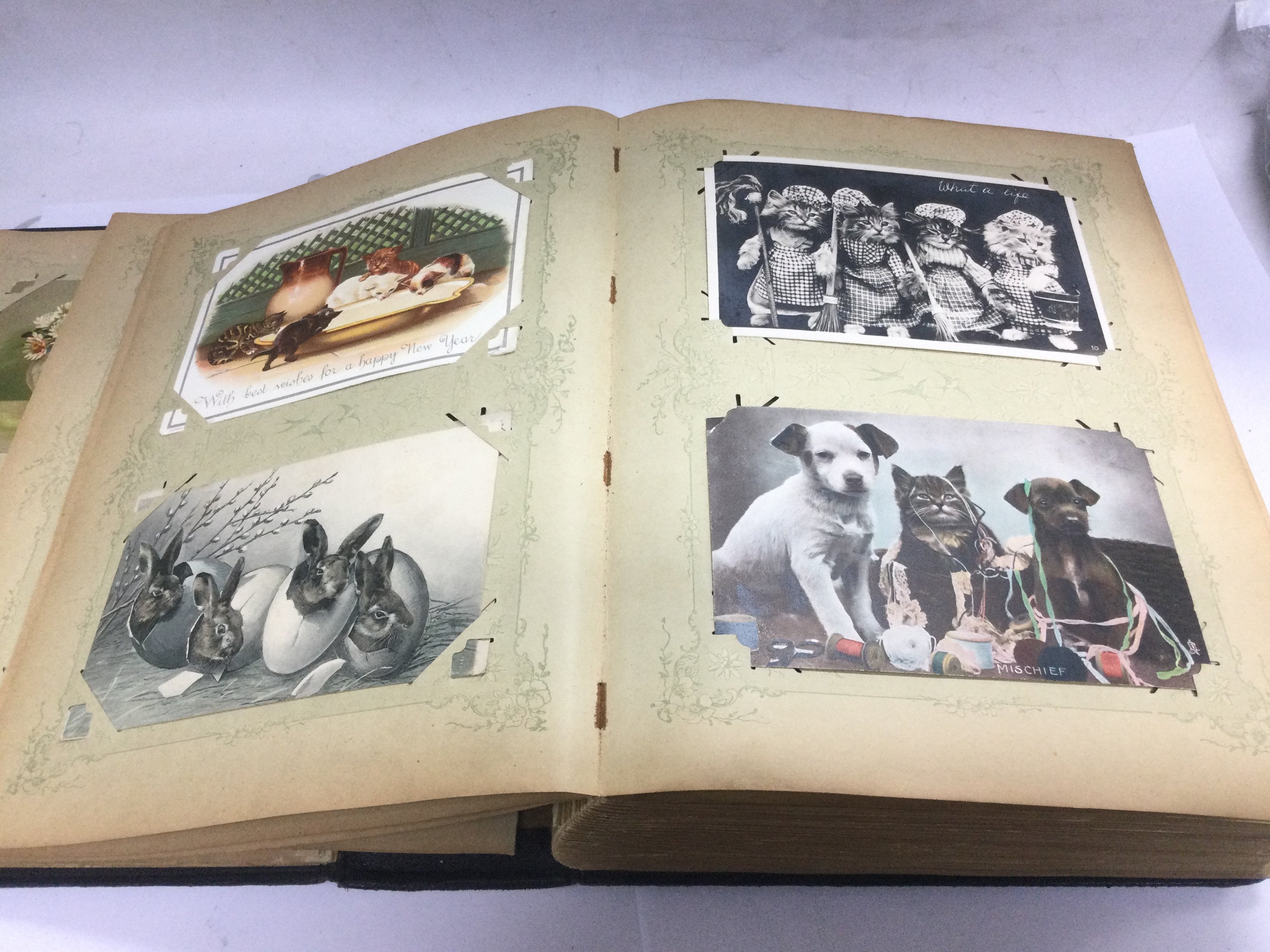An album containing over 150 postcards on various subjects including Easter, Christmas etc.