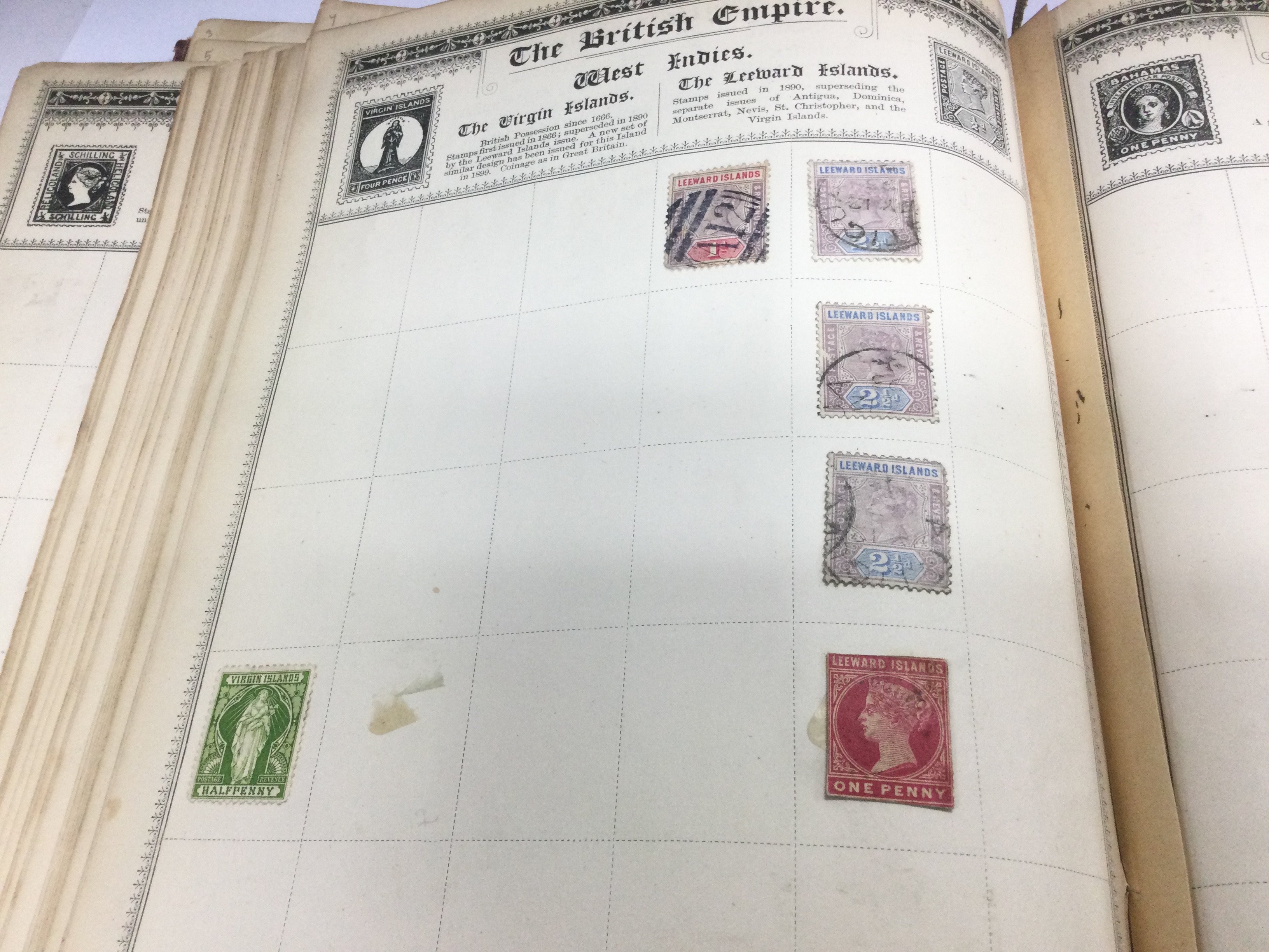 An interesting Empire Postage stamp album containing early Victorian circa 1840s onwards used world stamps. The album includes a rare Russian 1902 5k red violet stamp, a rare early Victorian Leeward Island stamp with cut edges and many others. Shipping category B.