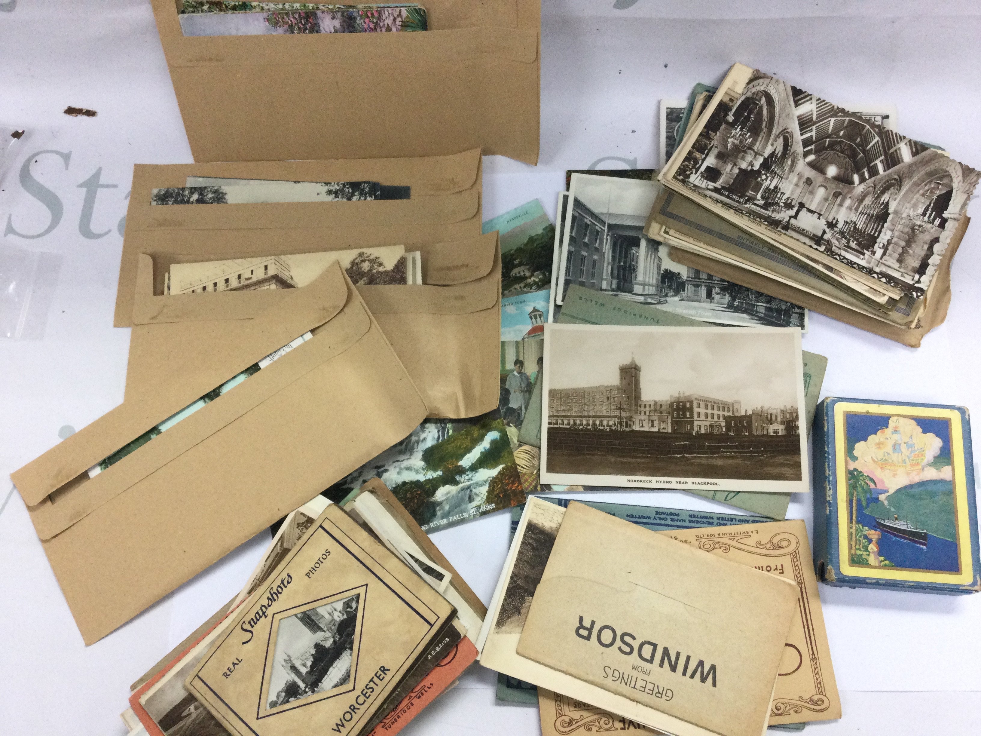 A collection of vintage UK postcards, some world and a pack of Panama souvenir playing cards made in USA . Postage category A