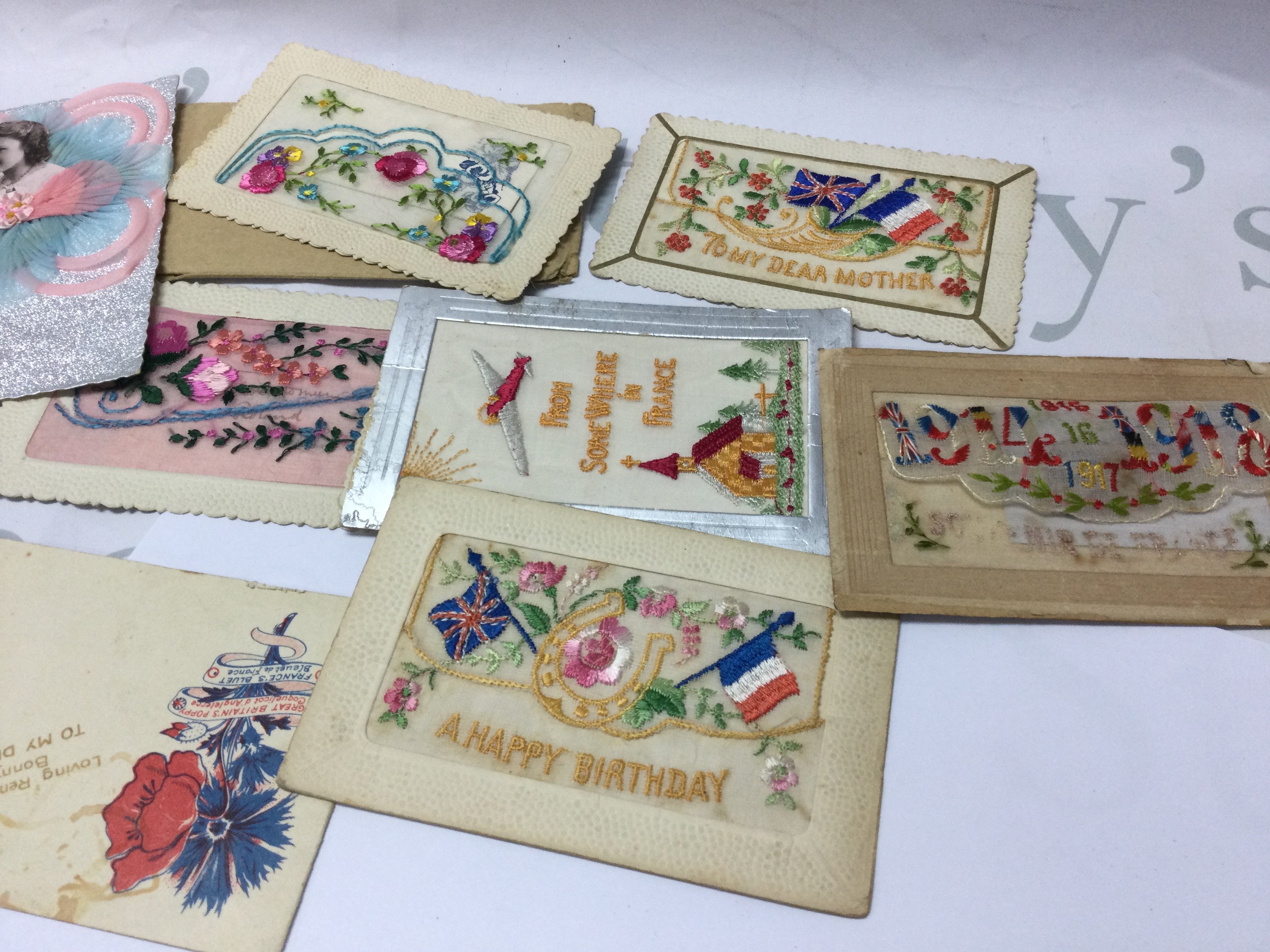 A small collection of French silk postcards.