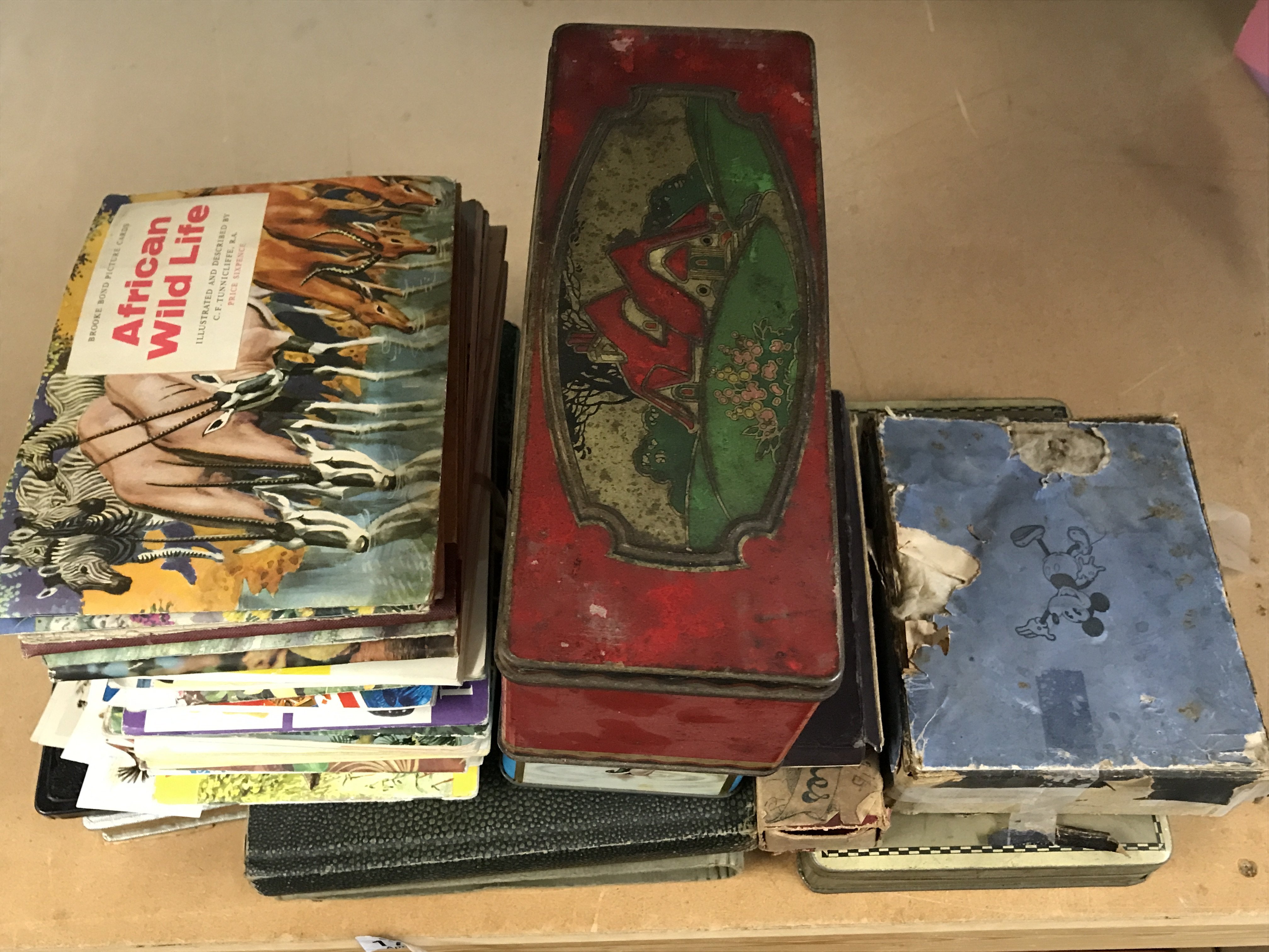 An early 20th century set of Mickey Mouse coloured slides and other vintage slides, large quantity of cigarette cards including players, copper players ashtray etc. postage category C