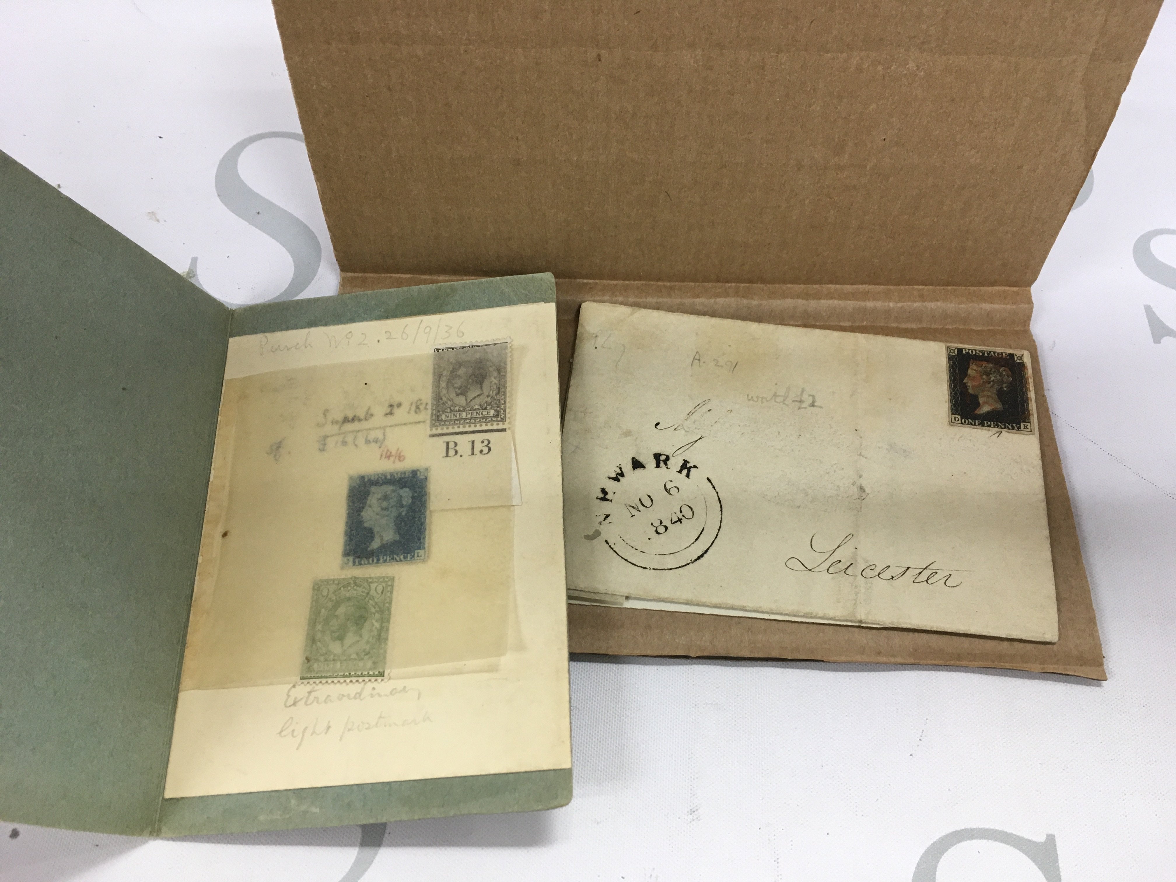 A small assortment of stamps including a penny black and a 2p blue stamp.