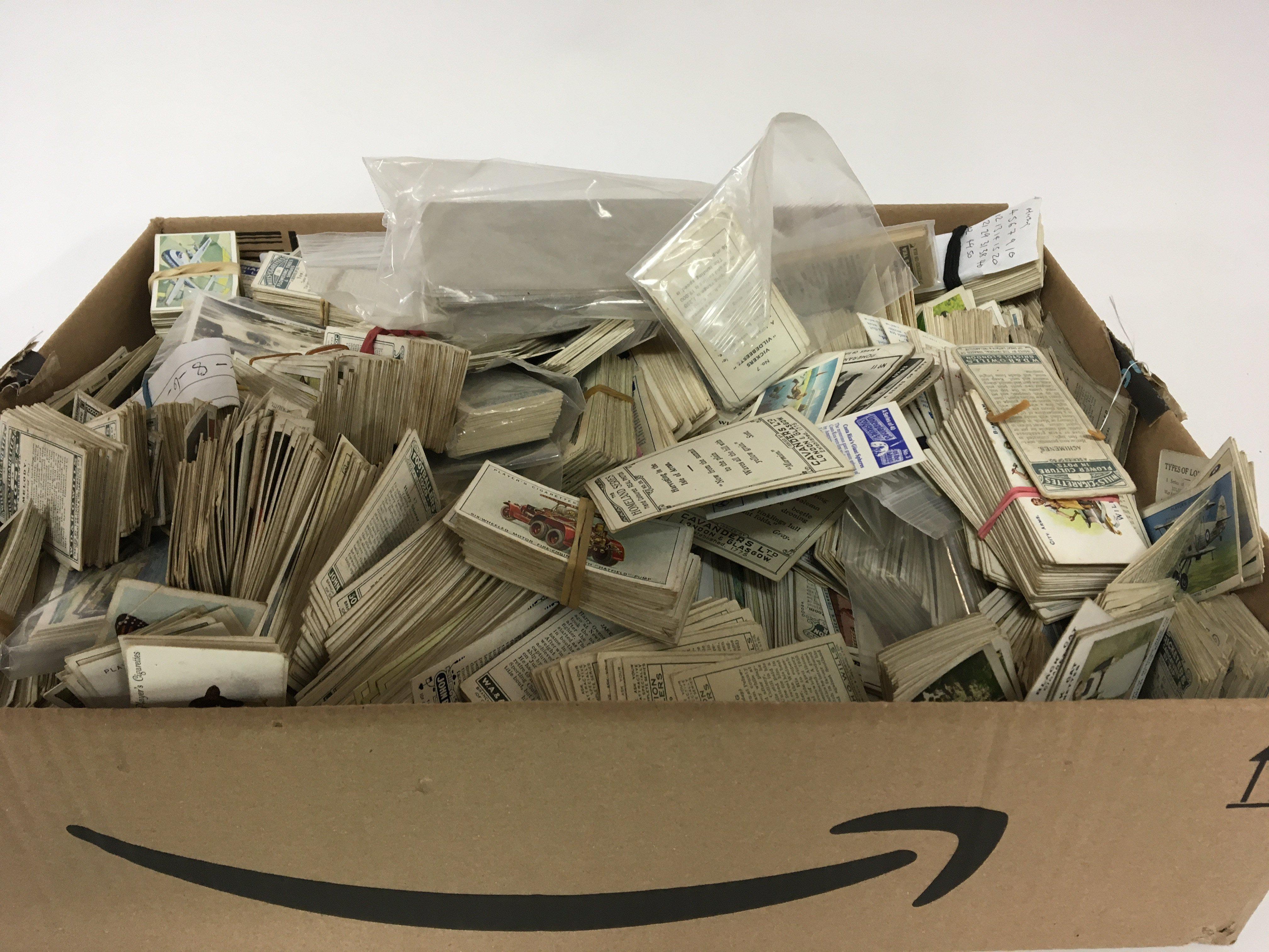 A box containing a large collection of sets and part sets of cigarette cards.