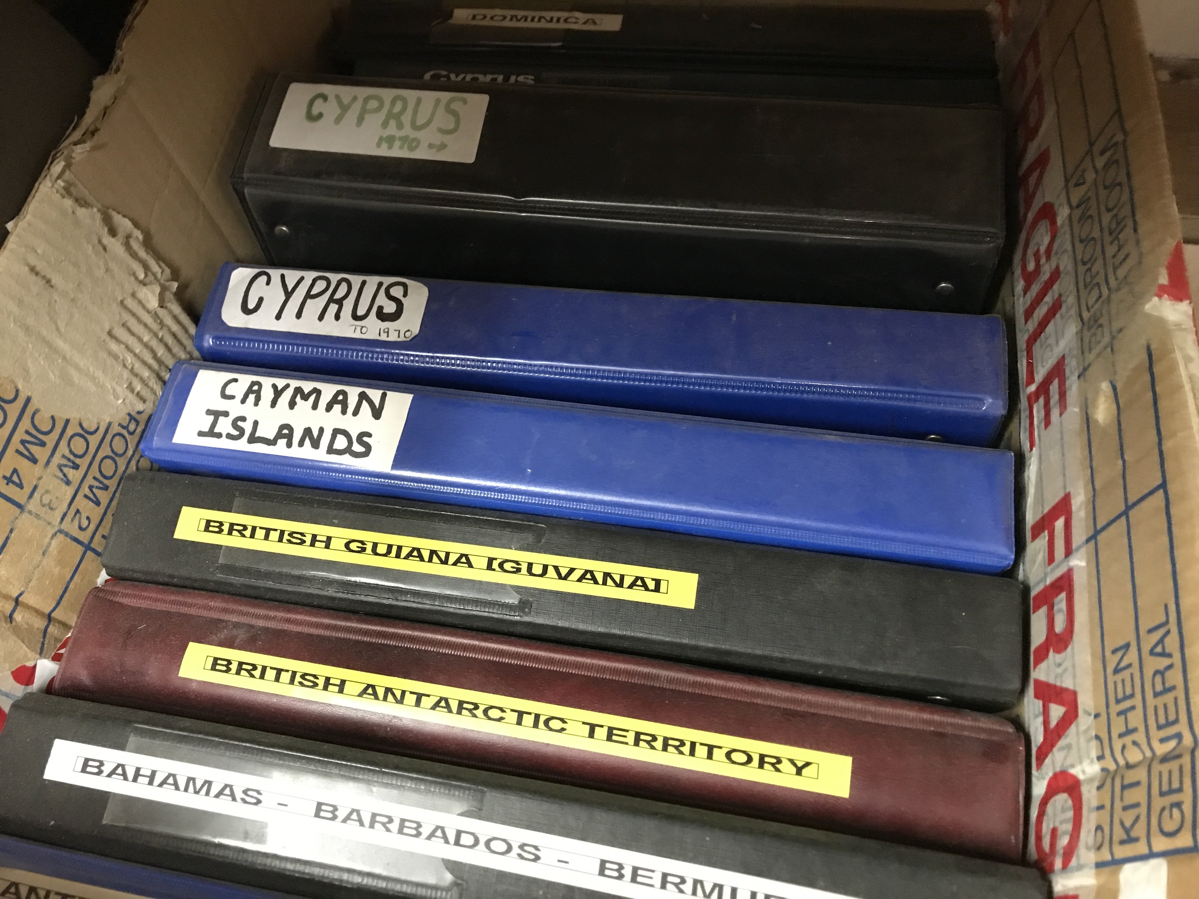 A box containing nine albums of world stamps