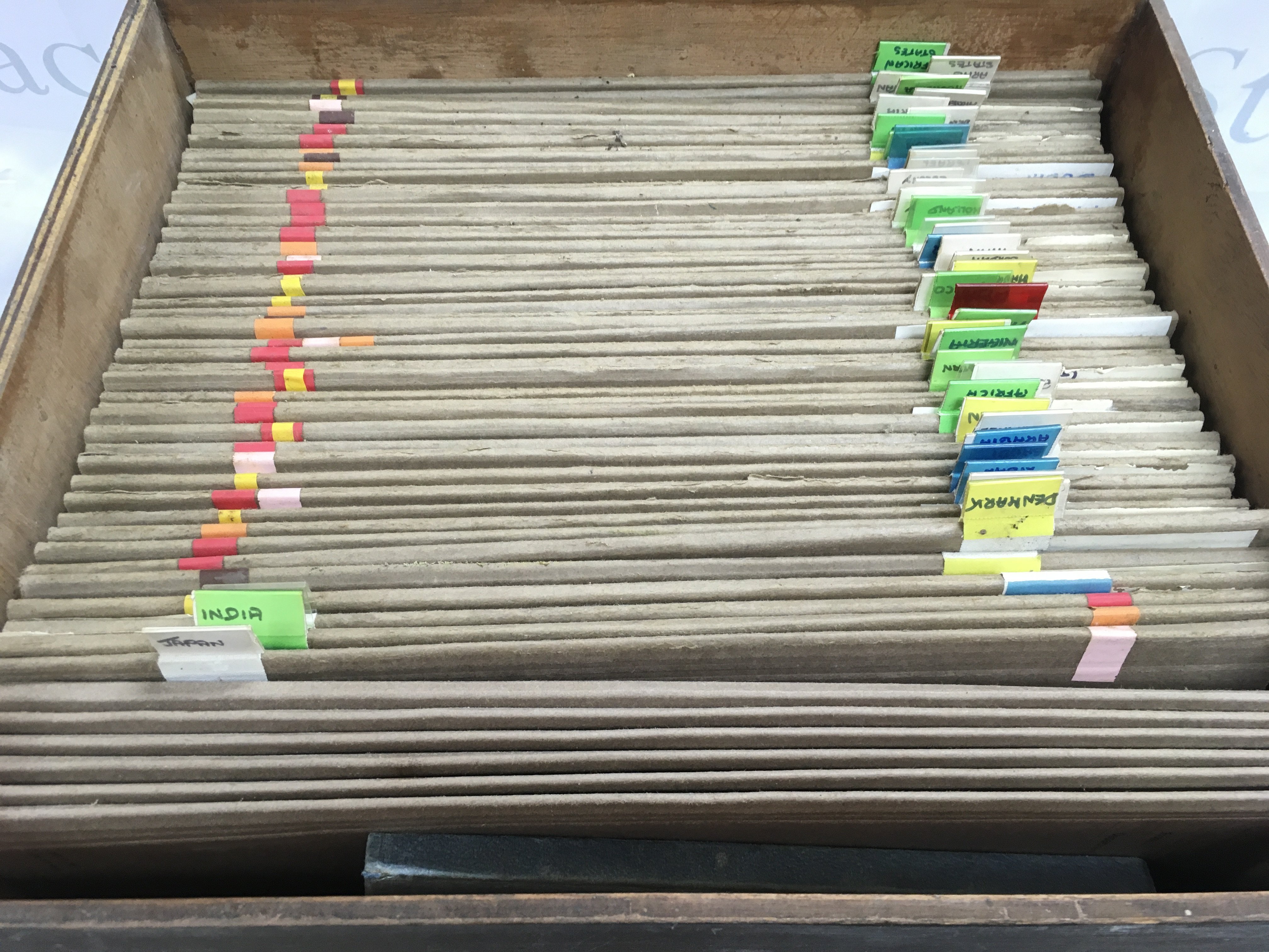 A box file of world stamps there is some water damage.