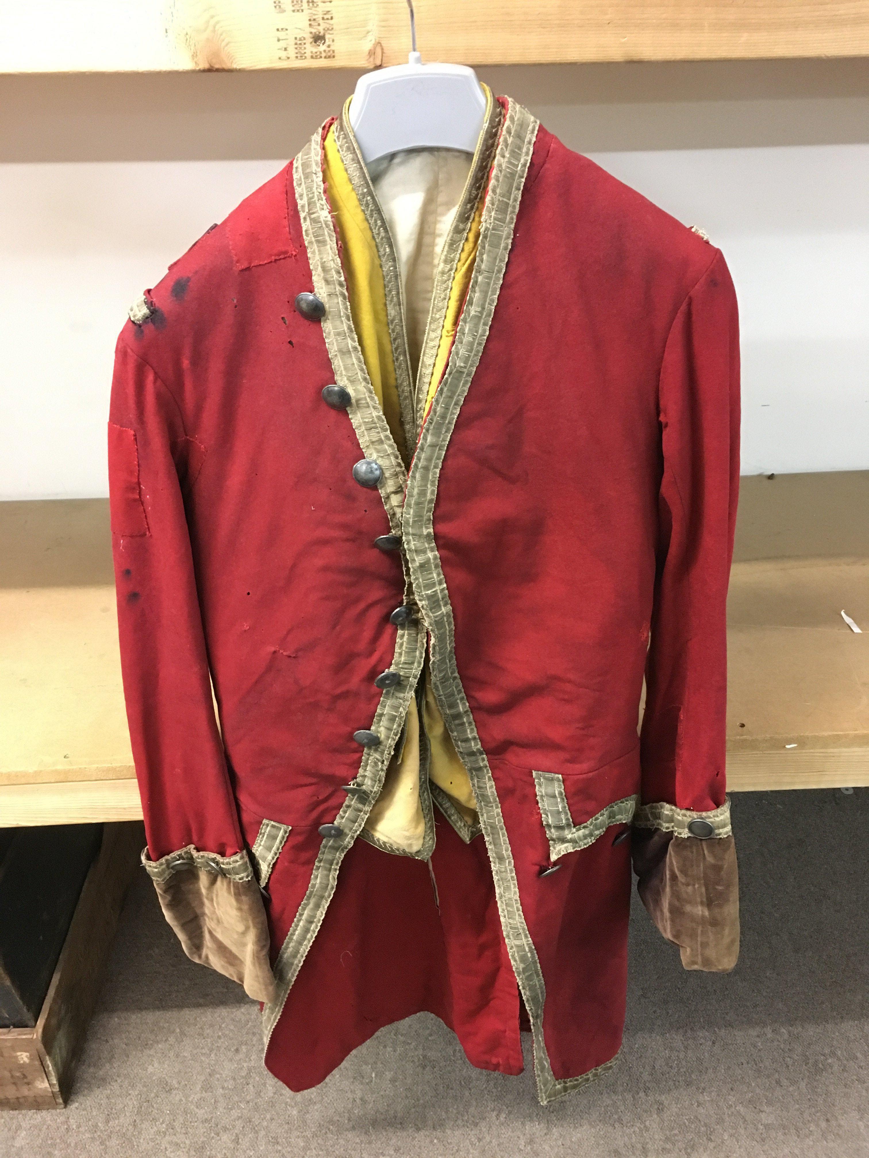 An 18th century red frock coat with waist coat. Postage category C