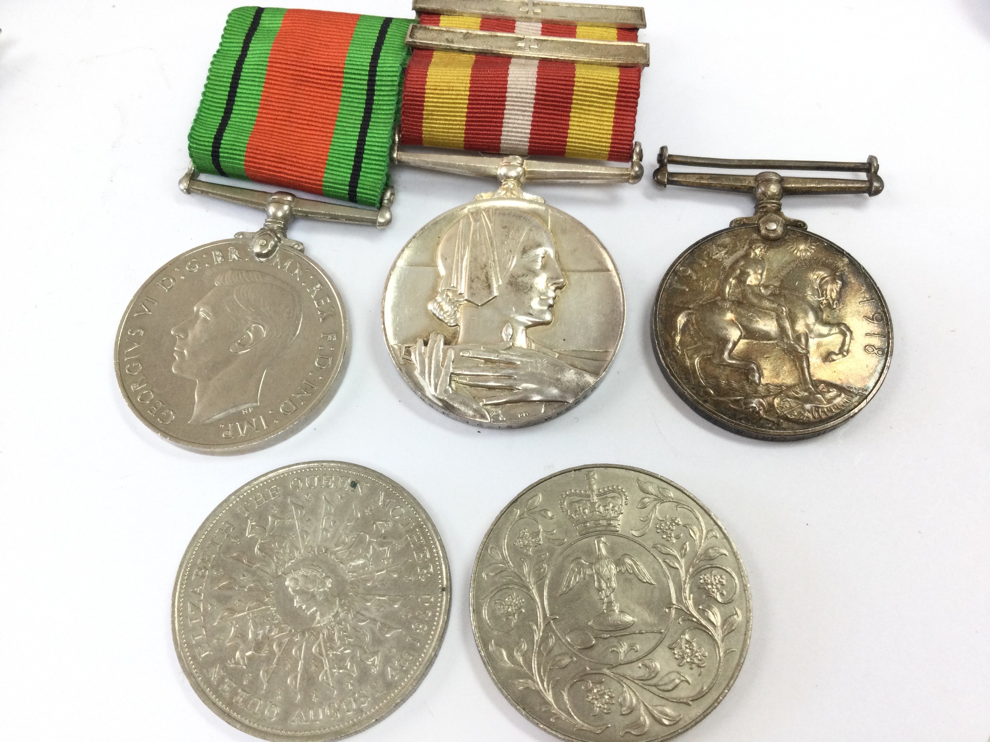 A collection of WW1 & 2 medals including a WW1 war medal presented to a PTE. P. Cartier. IR.GDS, Volunteer Medical Service Dress Miniature Medal with three clasps presented to a Mrs. Phyllis A. Webber. Also Including Two commemorative coins Postage category A