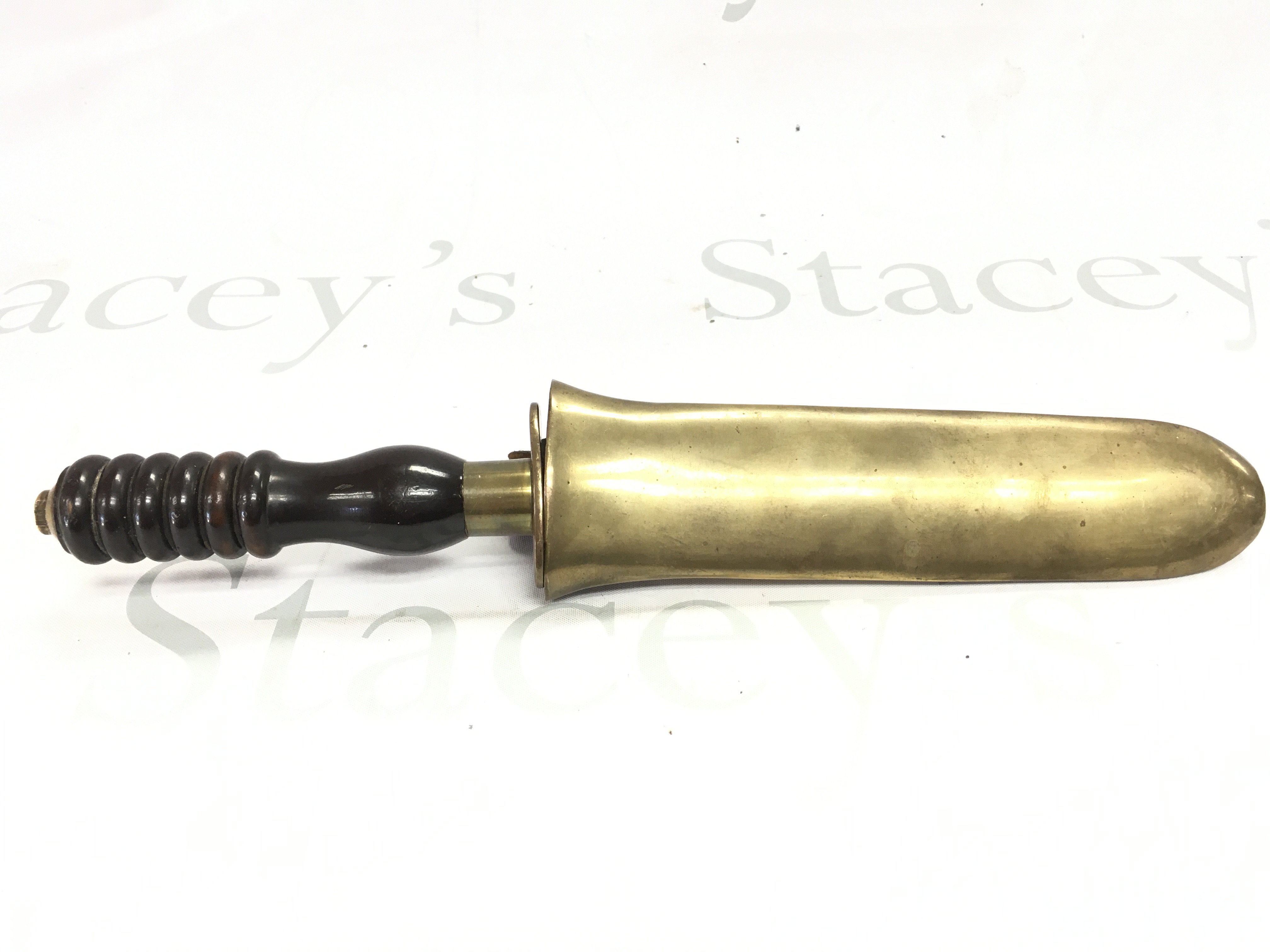 A Siebe Gorman diving knife, with a brass collar, turned handle, stamped makers mark on the blade and a brass sheath. Blade 19cm long. Total knife length approximately 36cm.