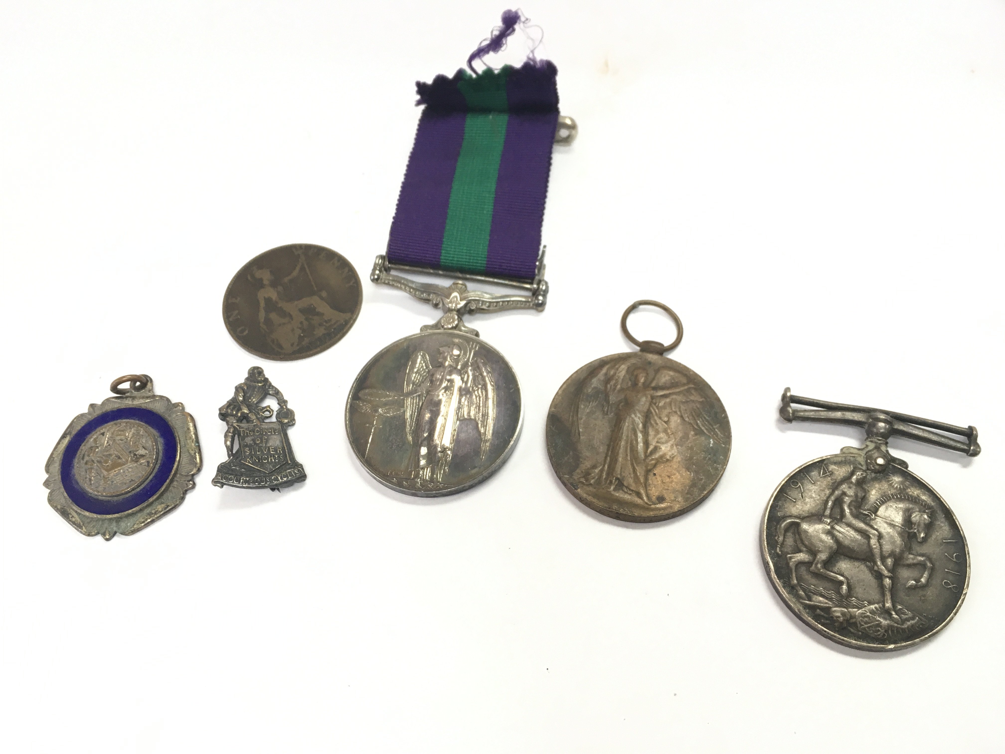 A British General Service medal with Cyprus bar presented to 5048190 A.C.2 E.R Kirby R.A.F, Two WW1 presented to L-1113 DVR.C.A Bridges .R.A including a defence medal and a victory medal. A circa 1920s vintage The Raleigh Cycle Company promotional/advertising pin badge . Trench art WW1 needlework Postage category A