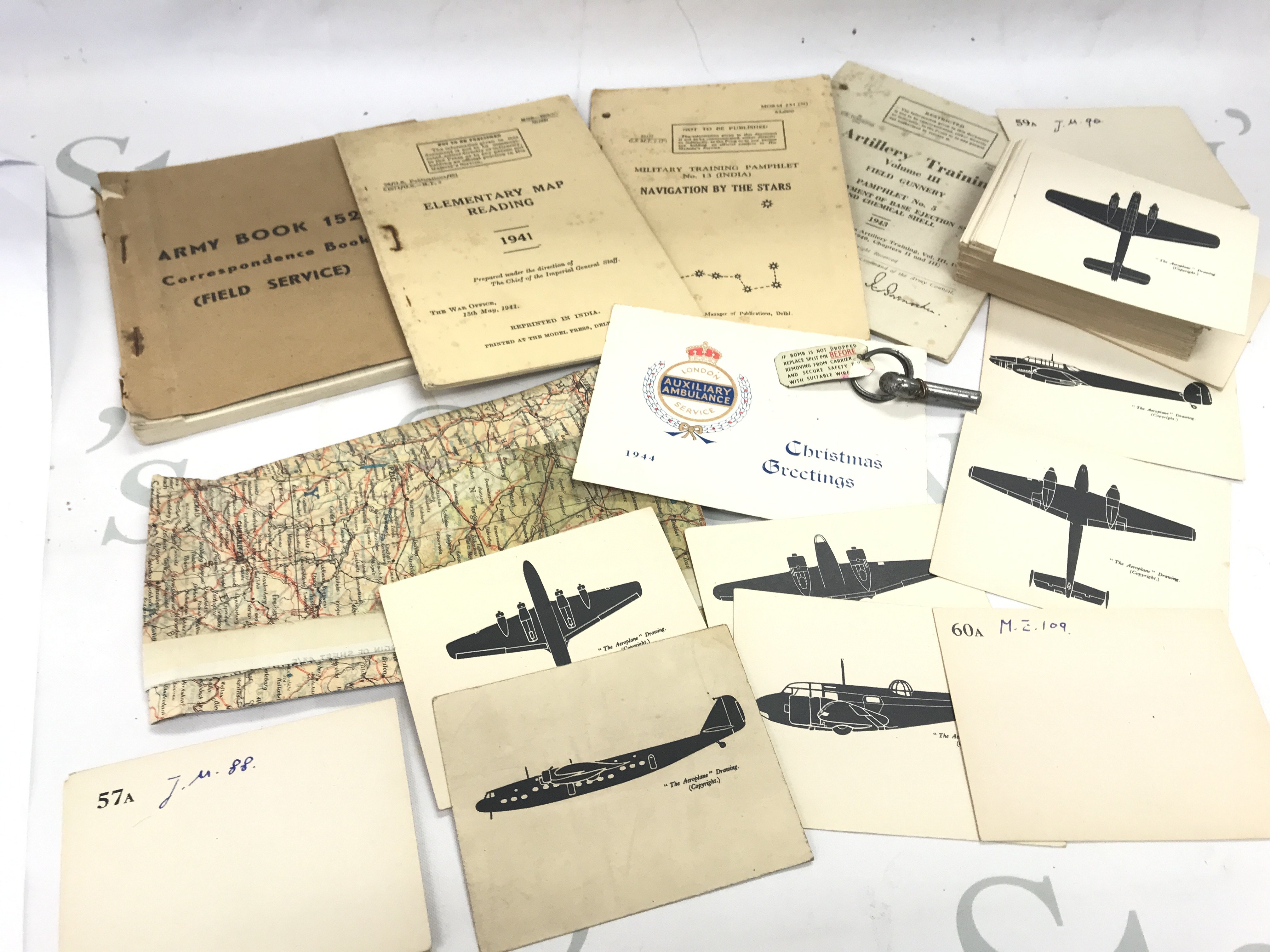 A WW2 map, Silk set of Aeroplane ID cards, other WW2 booklets and a bomb split pin. Postage category B
