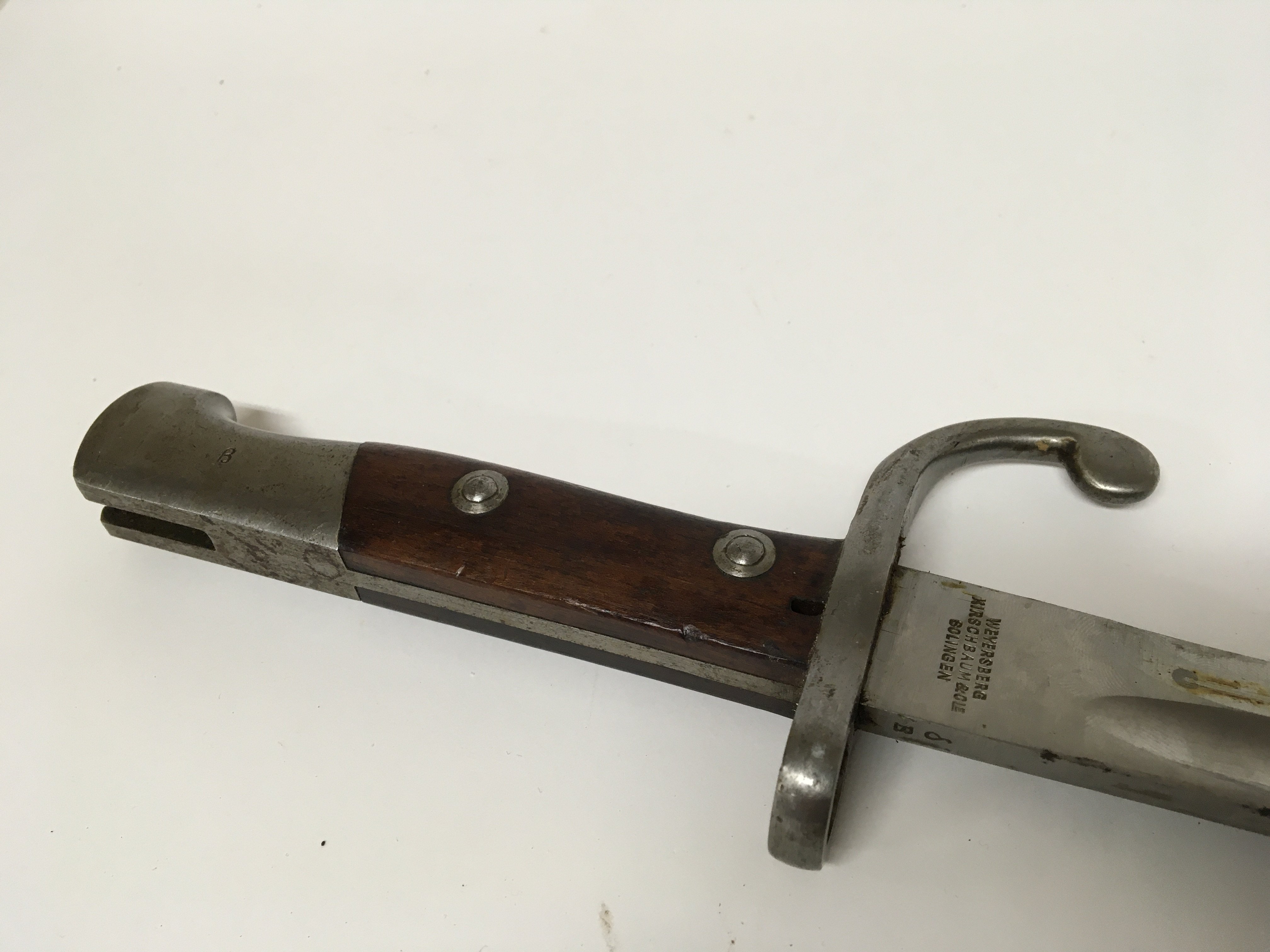 A Brazilian 1908 pattern bayonet commisened by the Brazilian government made by Weyersberg Kirschbaum Solingen. The number on the quillion matching on the brass fittings of the leather scabbard the top section of the bayonet marked with a B.