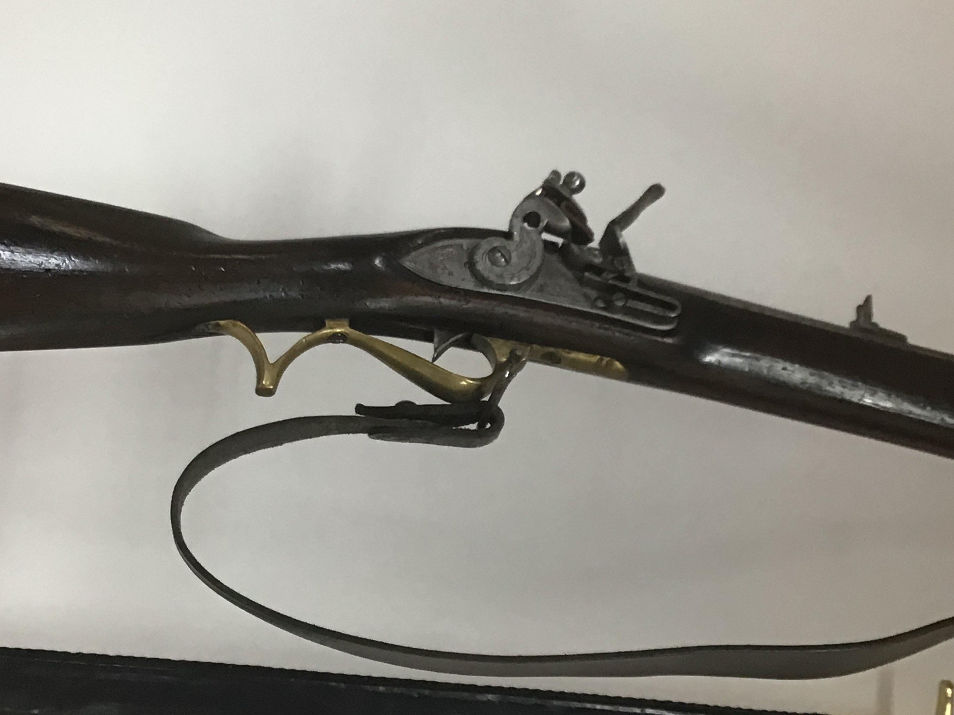 A replica Tower Flint lock Rifle Musket with brass fittings and steel barrel the flintlock action with Tower Proof marks sold with a bayonet. PLEASE NOTE A FIREARMS LICENSE IS REQUIRED TO BUY THIS LOT VIEWING AND COLLECTION BY APPOINTMENT ONLY.