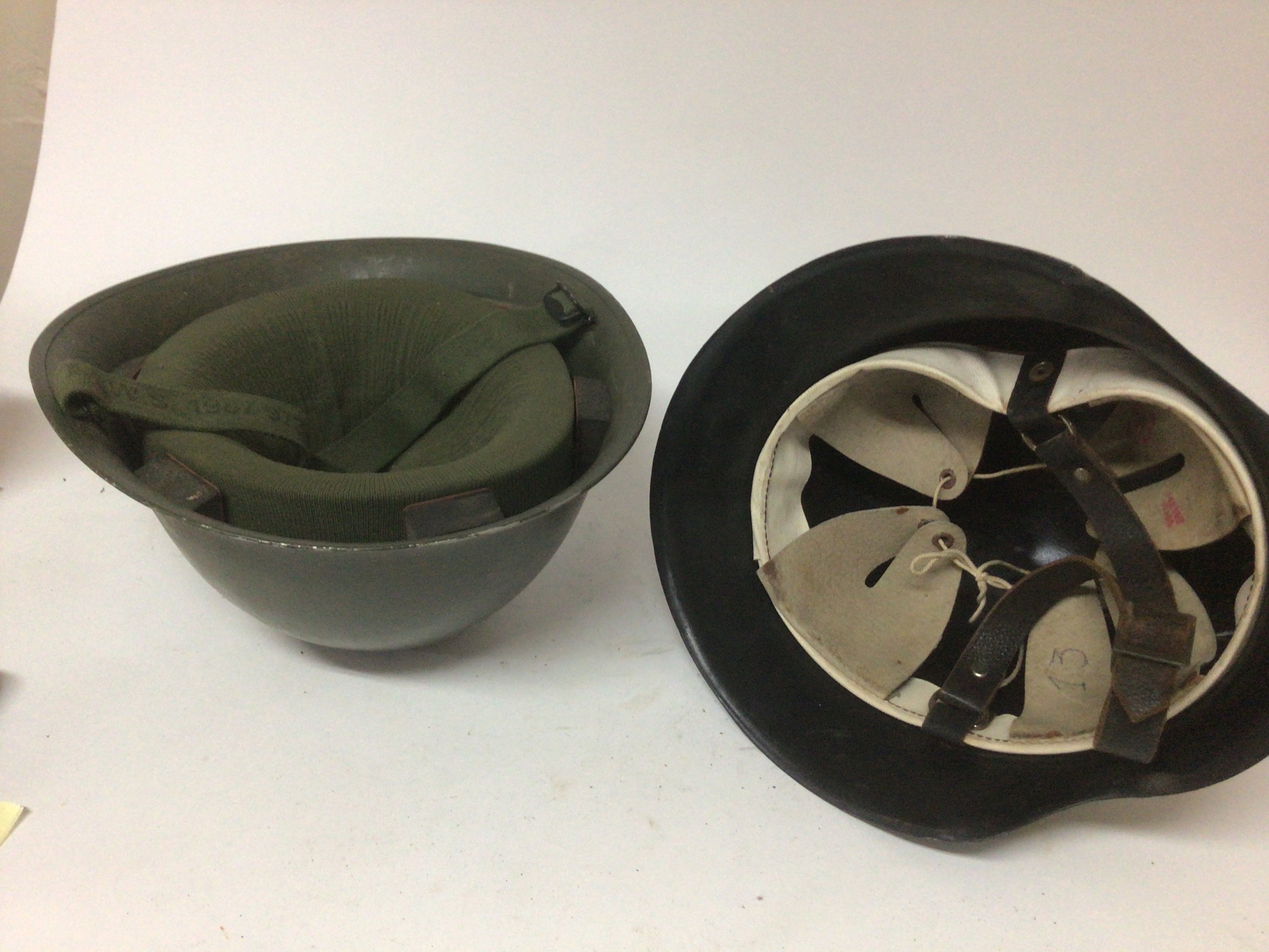 A British Military Hat 1977 M.W.S and a German Third Reich type black painted helmet with a white liner and stamped 3273 (2)- NO RESERVE