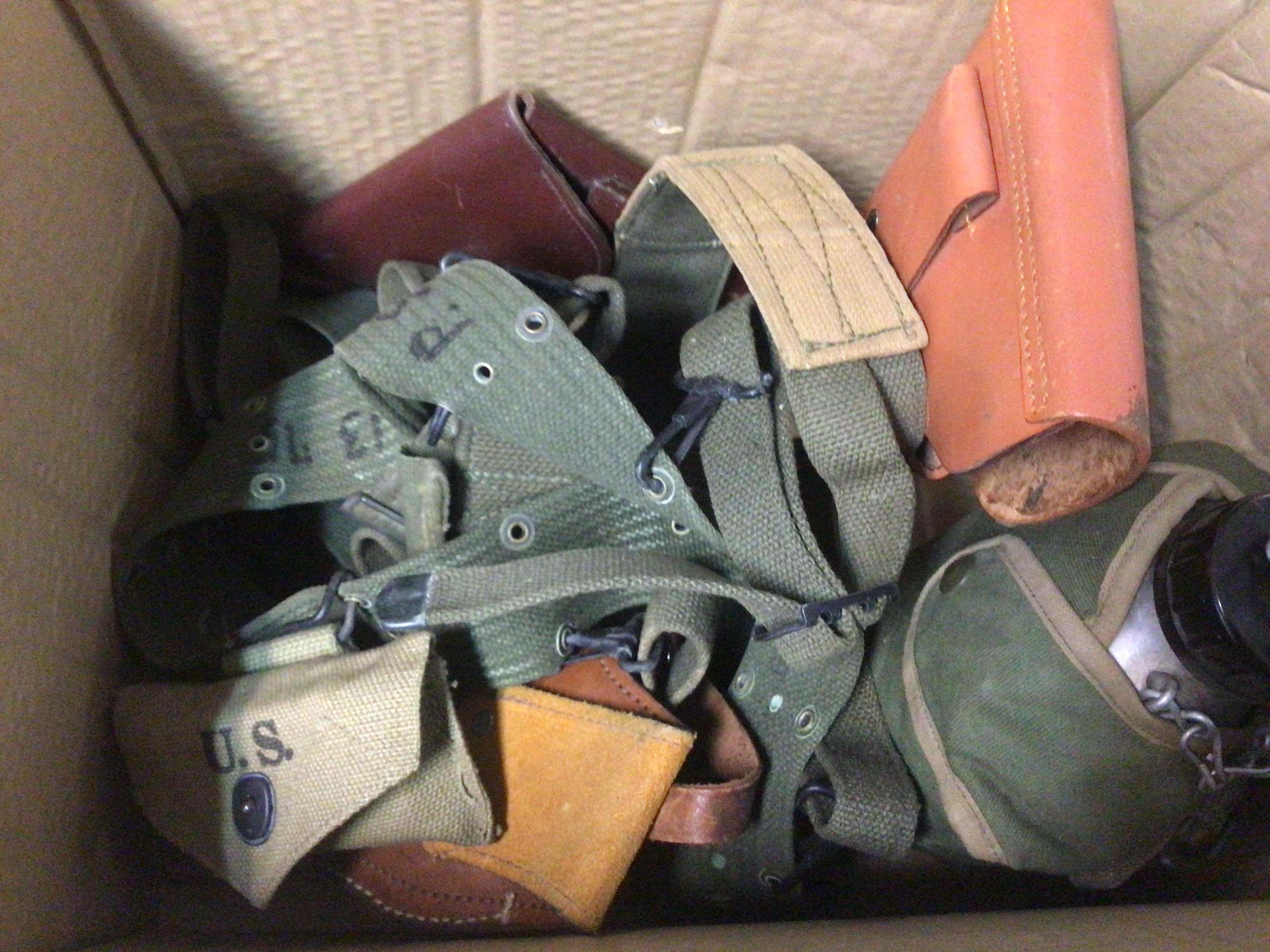 A box containing military webbing a military wooden box with liner and non military leather pistol holsters and other oddments.- NO RESERVE
