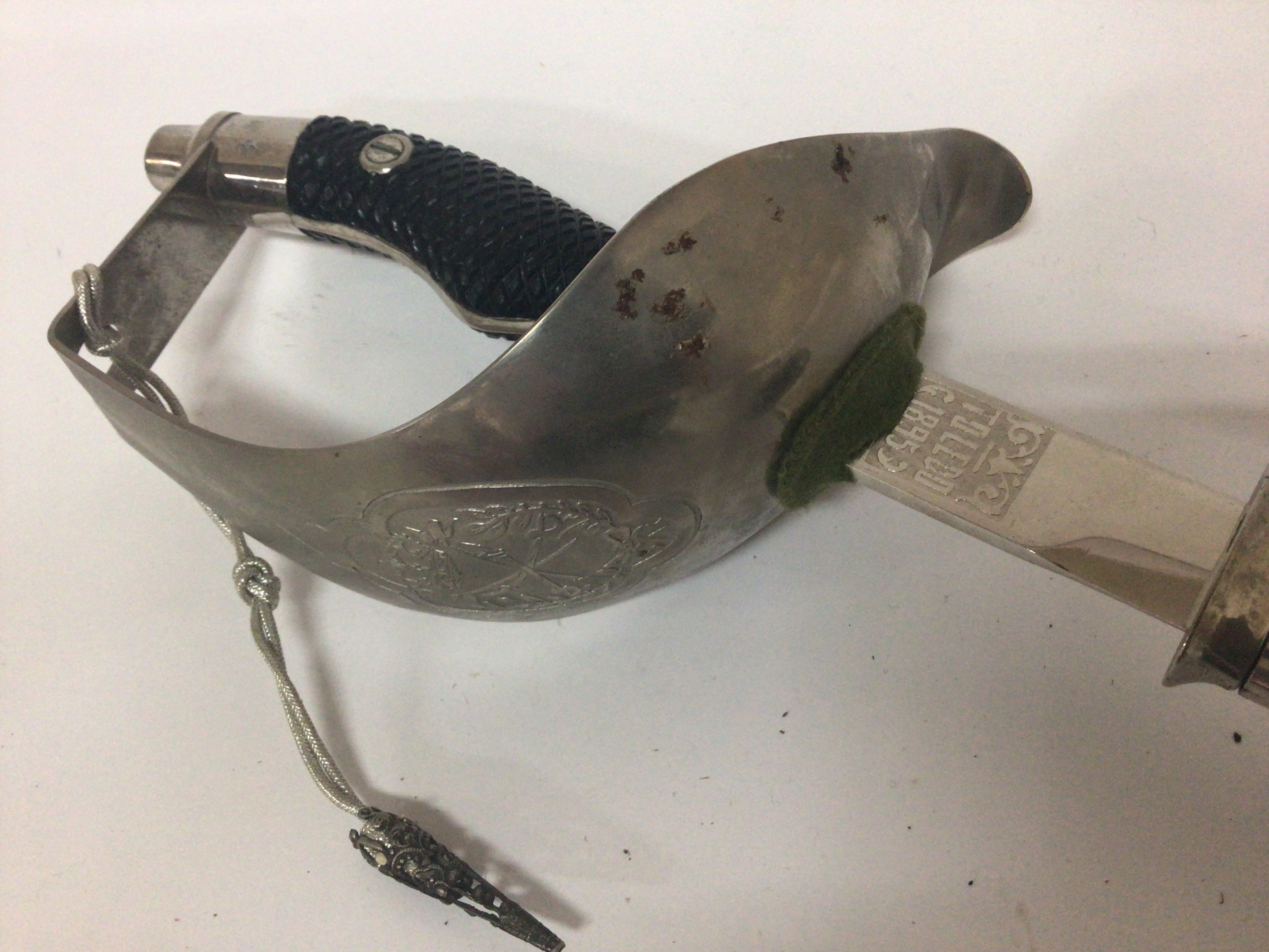 A Toledo 1895 pattern sword with a shaped grip full cross guard with etched emblem. Length 98cm