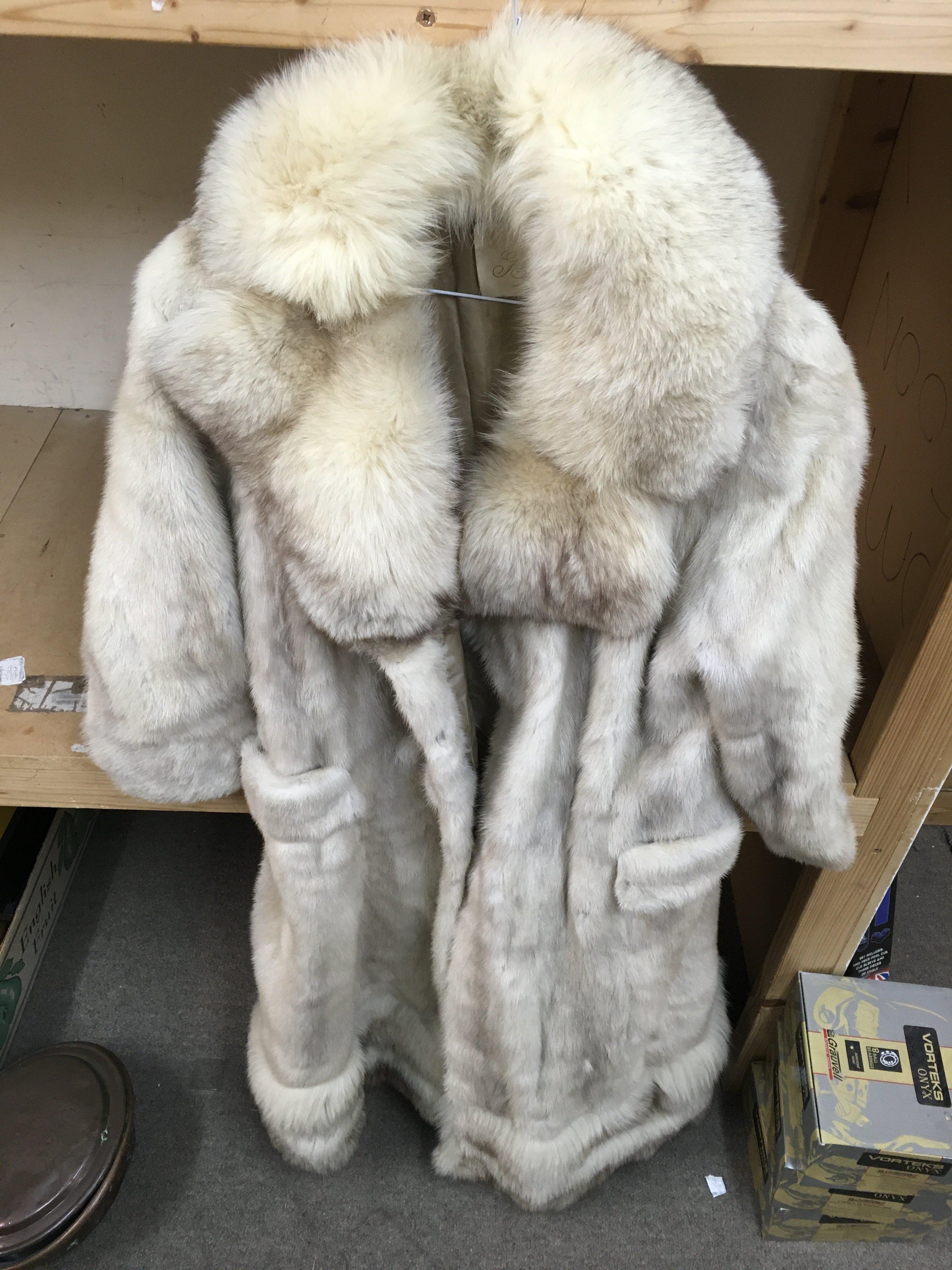 A collection of fur coats and scarfs.