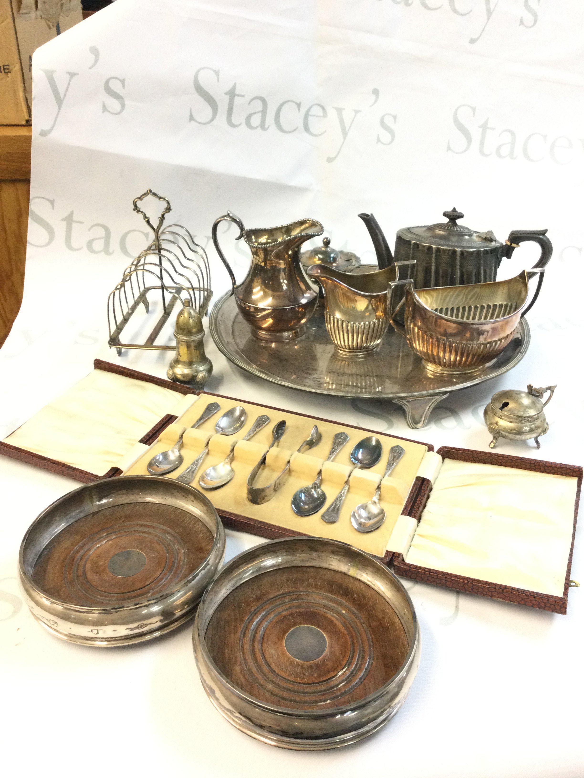 A collection of silver plated items including a dish, spoons, silver hallmarked coasters. Postage category C