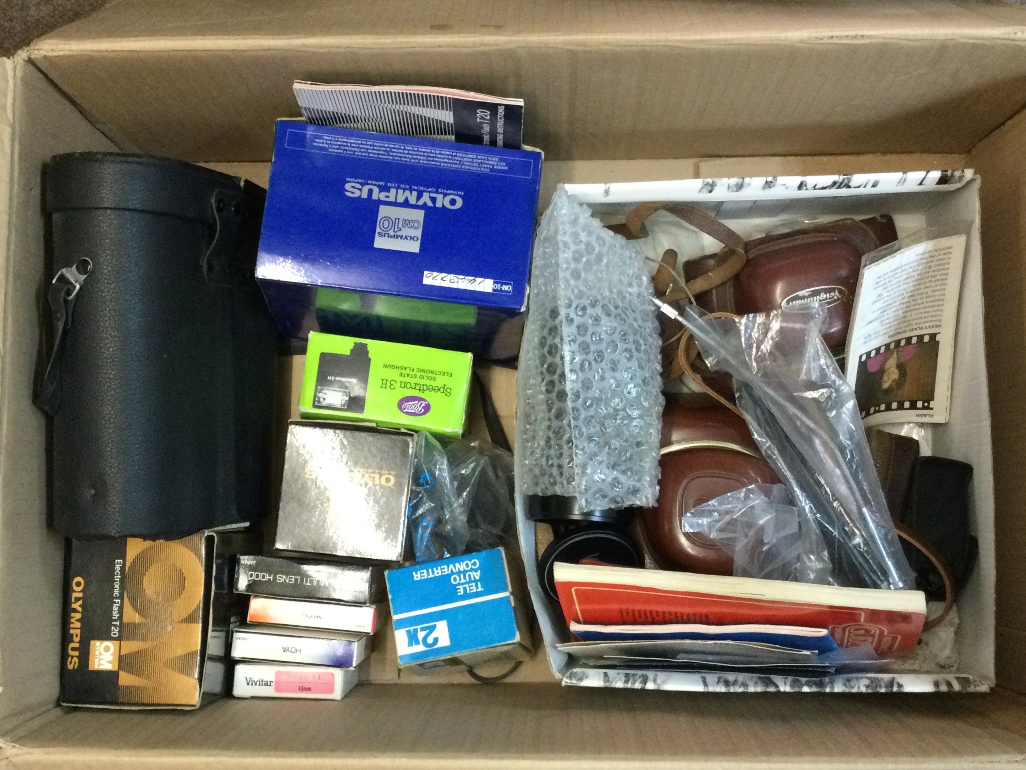 A collection of various camera equipment including an Exakta Vader 11a, Voigtlander Vito CL, Chinon 7x50 binoculars , Olympus OM10 etc