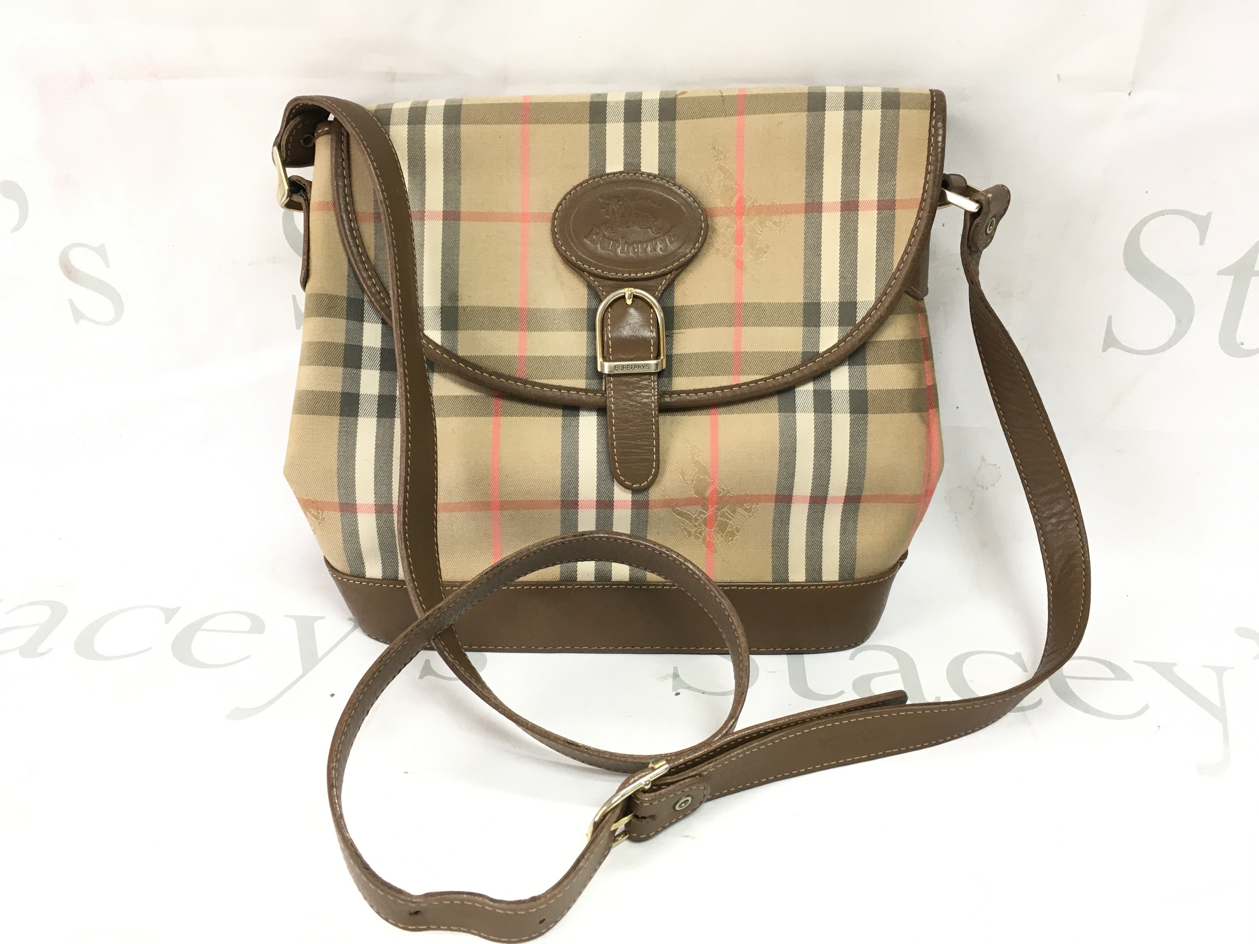 A Burberry beige in leather Crossbag . Postage category B